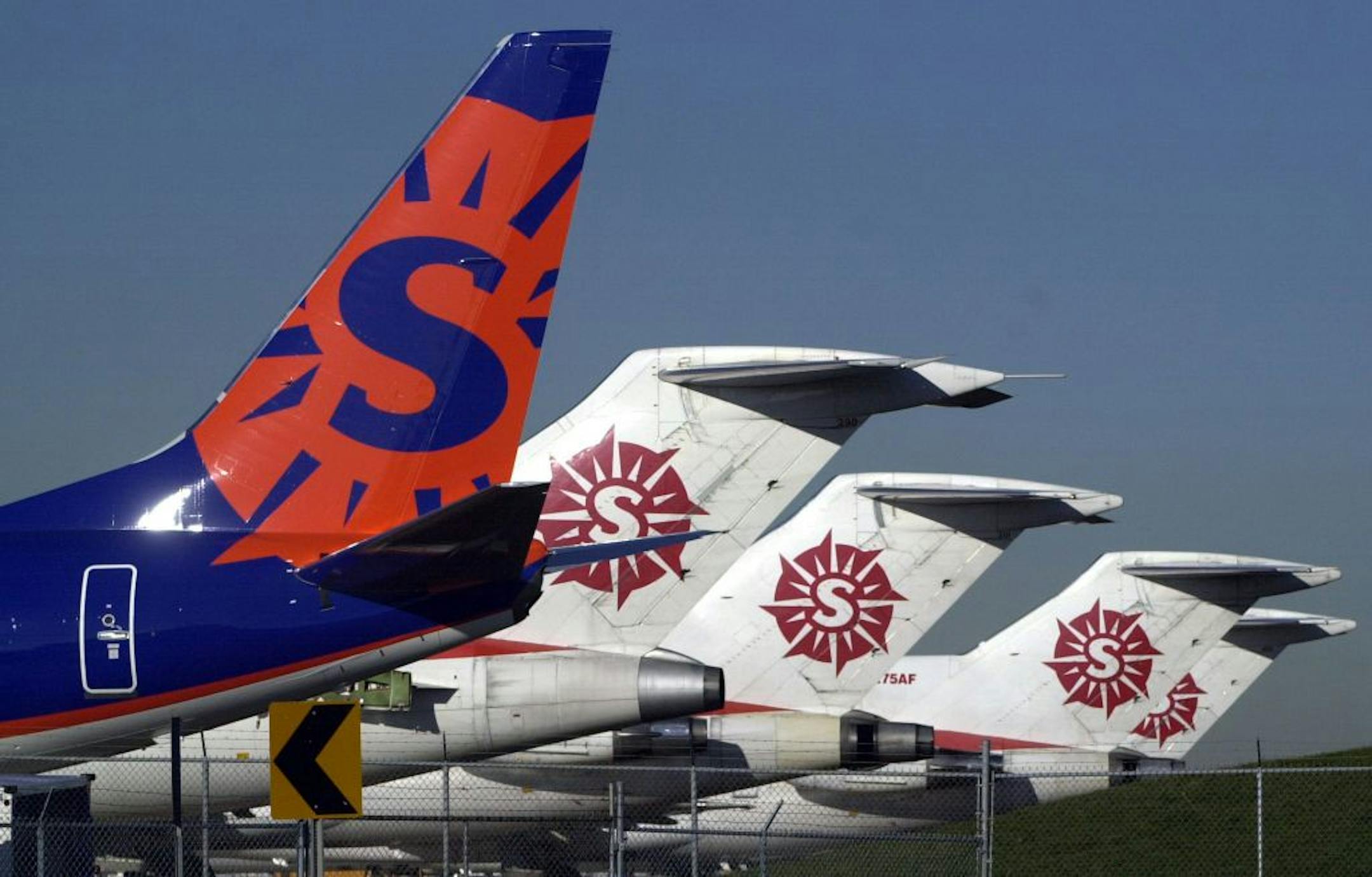THESE ARE OLD SUN COUNTRY PLANES> RETIRED FLEETS> THINK TWICE ABOUT USING. Sun Country Airlines' jets parked on the tarmac near main hangar for Sun Country Airlines' at the Airport.