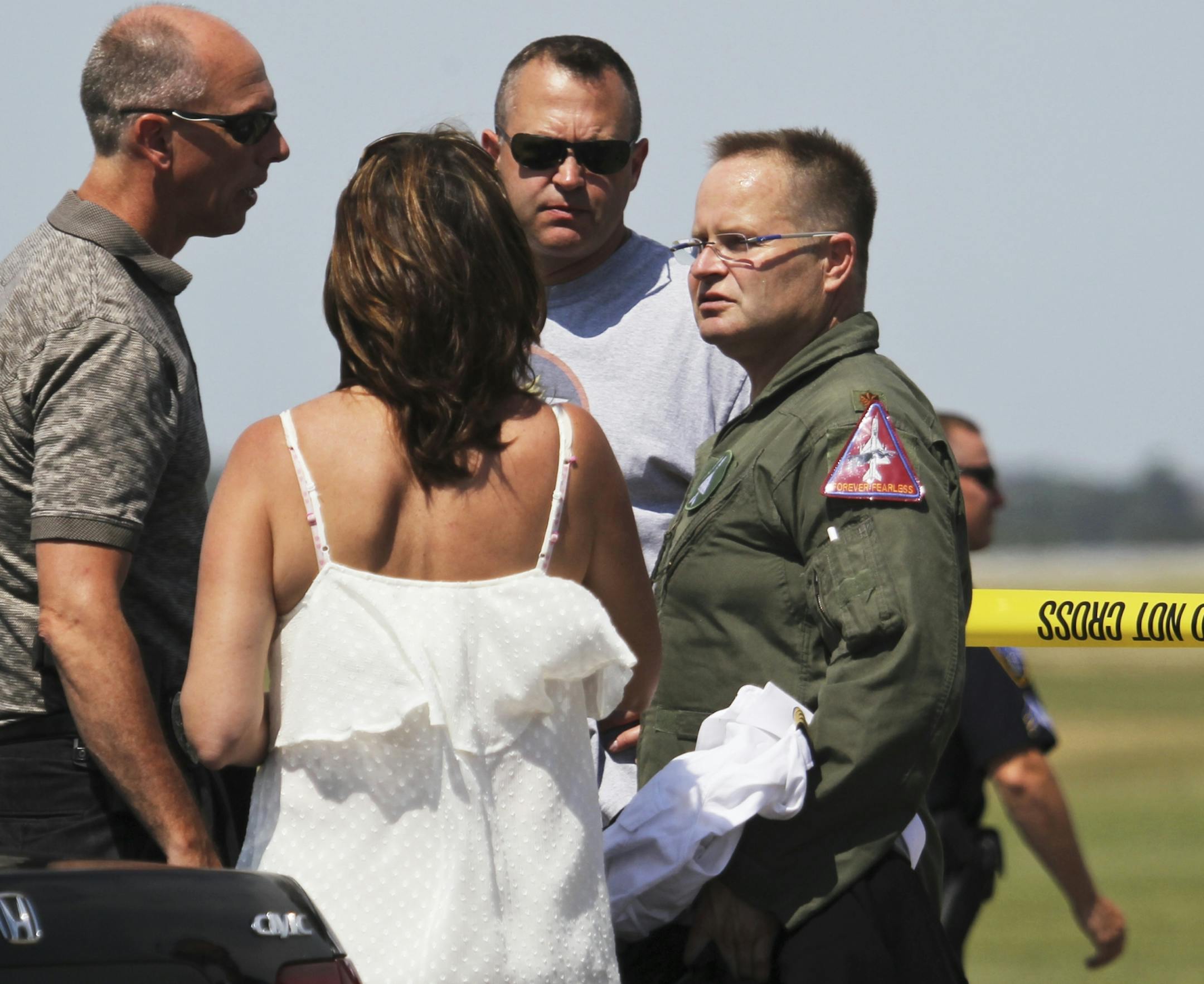 The MiG pilot, right, is interviewed by authorities after landing and crashing his Russian MiG at Flying Cloud Airport Thursday, July 12, 2012, in Eden Prairie, MN.