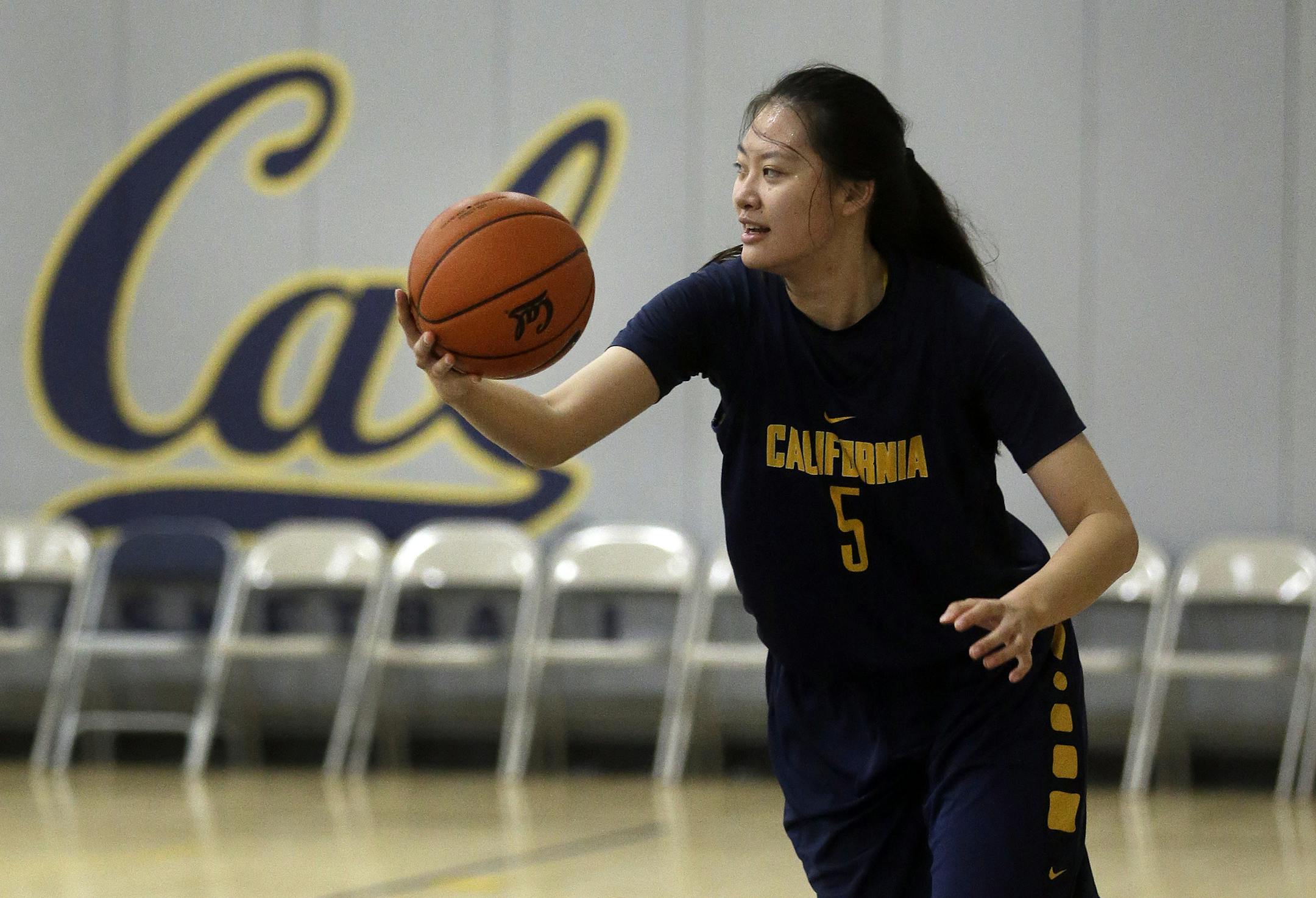 In this Dec. 12, 2015 photo, California's Chen Yue rebounds during a team workout in Berkeley, Calif. The 6-foot-7 freshman center, who is believed to be one of the first Chinese basketball players to play at a high college level, says she came to the U.S. to challenge herself both on the court and in the classroom. (AP Photo/Ben Margot)