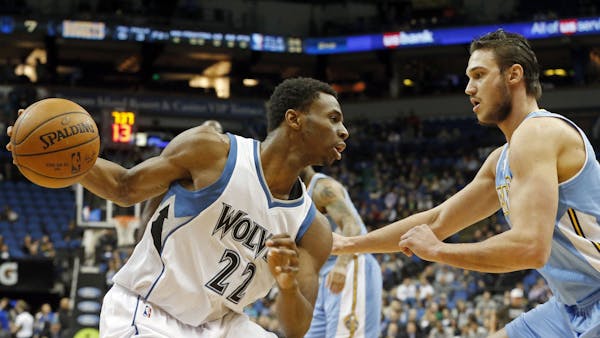 Minnesota Timberwolves&#xed; Andrew Wiggins, left, drives as Denver Nuggets&#xed; Danilo Gallinari, of Italy, defends in the first quarter of an NBA b