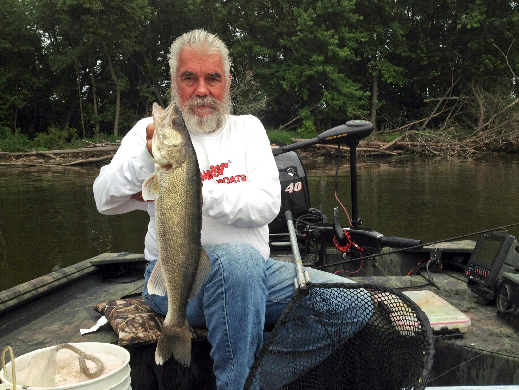Dick "the Griz'' Grzywinski of St. Paul and a 5-pound walleye he caught Thursday morning while fishing the Mississippi River downriver from St. Paul with Dennis Anderson.