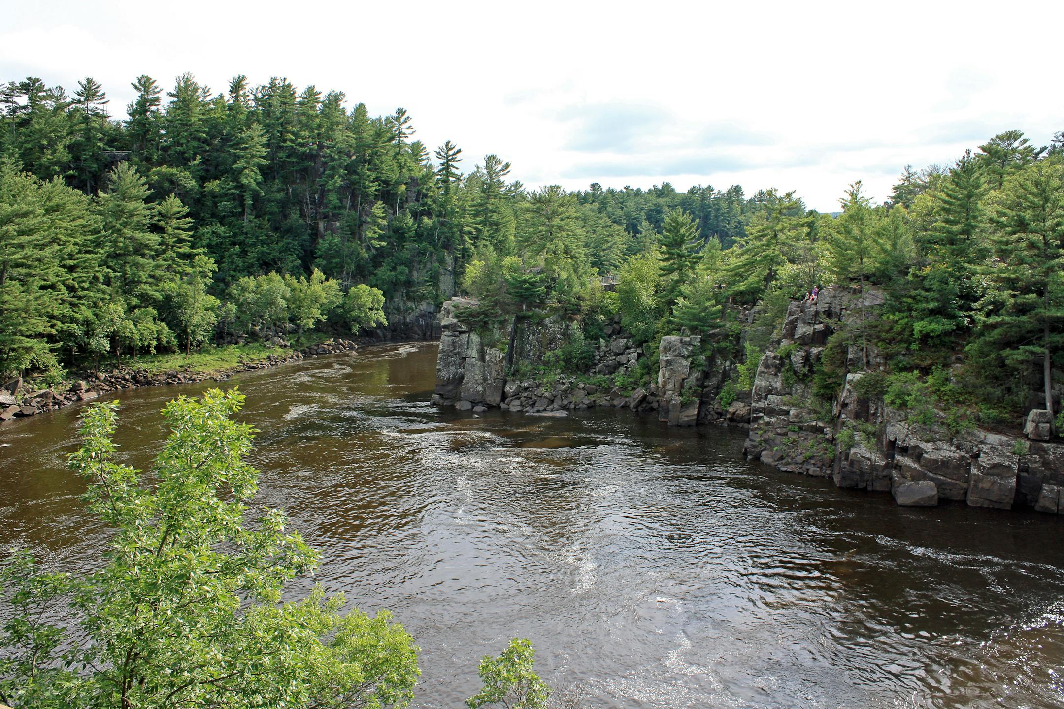 The St. Croix River cuts through a basalt gorge known as the Dalles of the St. Croix in St. Croix Falls. The dramatic rock walls are part of Interstate State Park, both on the Wisconsin and Minnesota sides of the river.