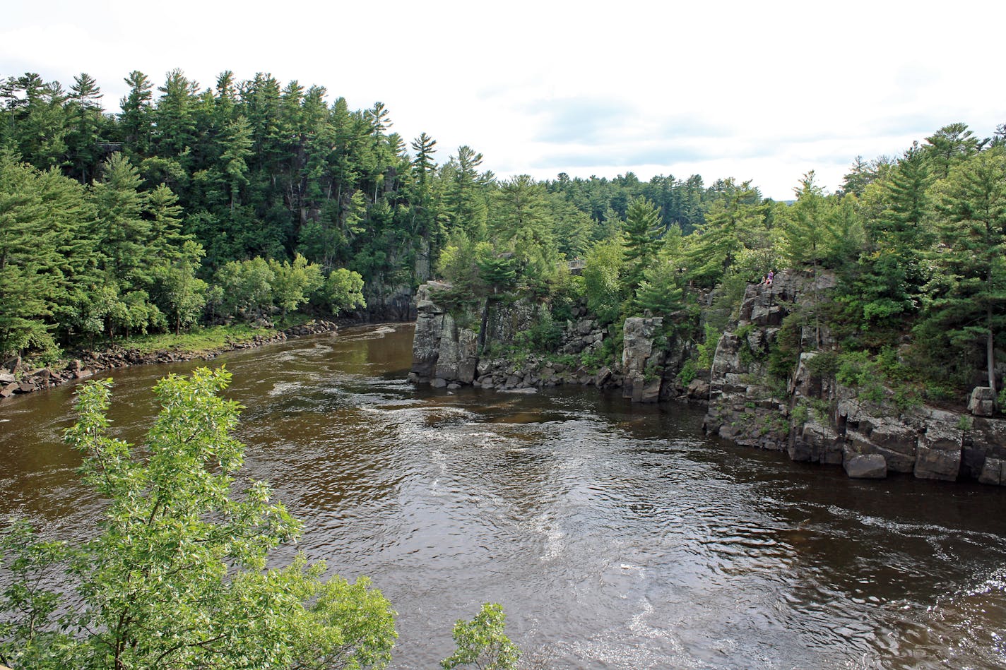 The St. Croix River cuts through a basalt gorge known as the Dalles of the St. Croix in St. Croix Falls. The dramatic rock walls are part of Interstate State Park, both on the Wisconsin and Minnesota sides of the river.