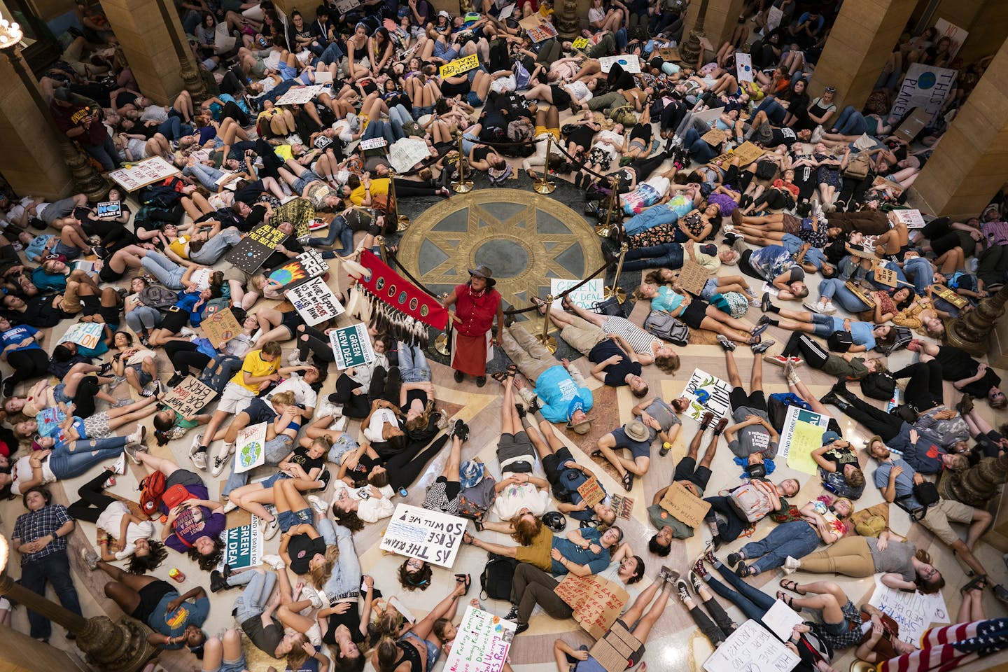 Protesters demonstrated with a "die-in" in the Minnesota Capitol Rotunda. ] LEILA NAVIDI &#x2022; leila.navidi@startribune.com BACKGROUND INFORMATION: Hundreds of protesters gathered to march from Western Sculpture Park in St. Paul to rally at the Minnesota Capitol to call for government action to fight climate change, part of a global day of climate protest on Friday, September 20, 2019. ORG XMIT: MIN1909201522464093