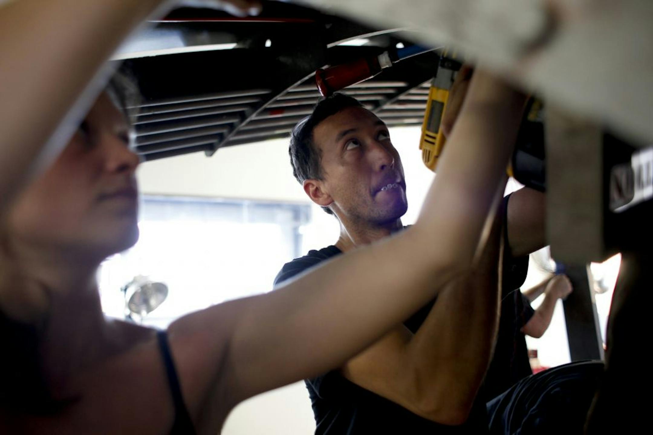 With five hours left before the final judging, Ben Arcand and Lela Beaumann work to the finish "Hunt for Red September," a submarine game conceived and built from scratch in 72 hours for this year's Red Bull competition "The game of games" in Minneapolis, Minn. on Sunday, July 22, 2012. About a dozen of engineers, artists, designers and friends are collaborating to win the national competition.