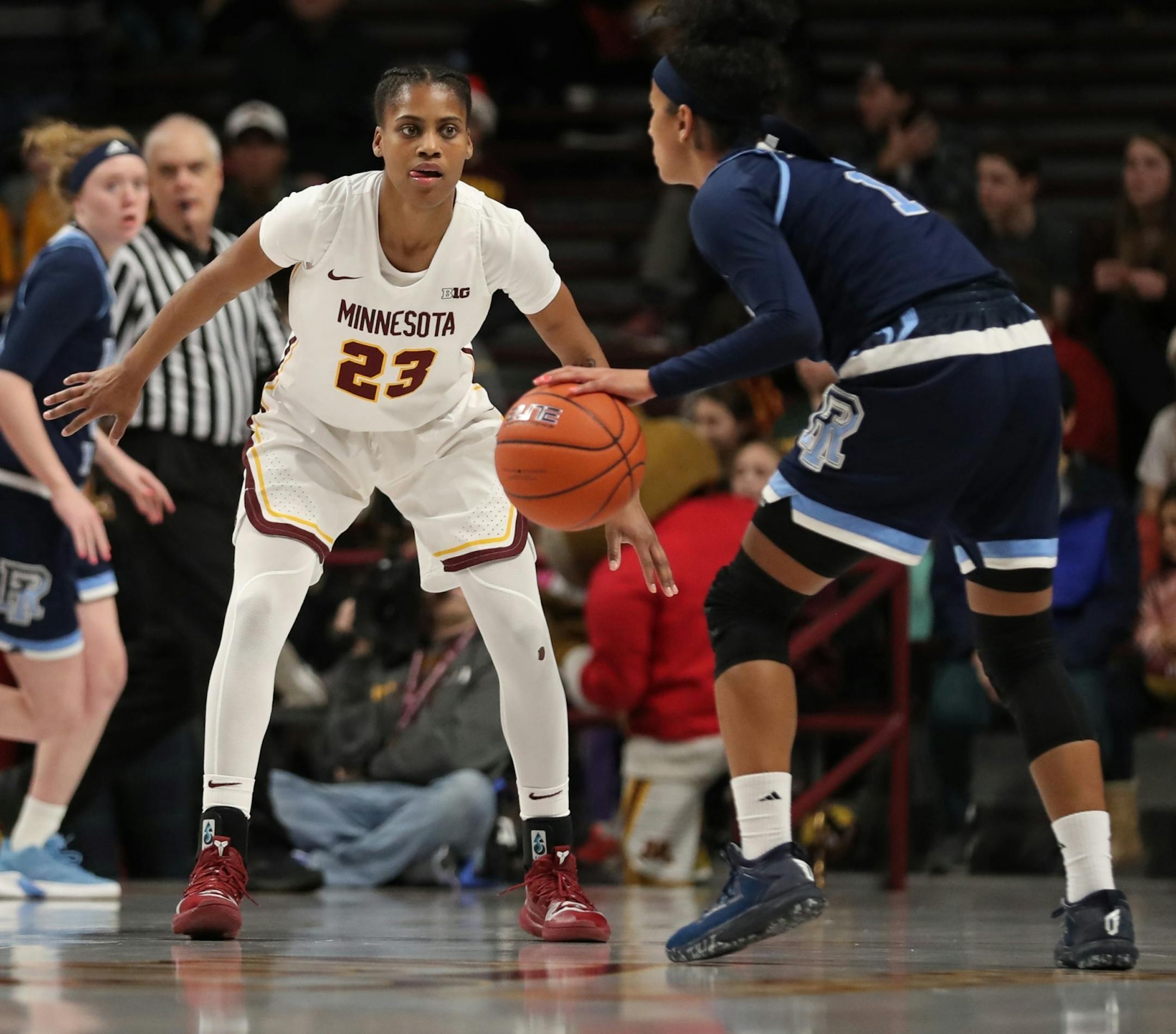 Minnesota Golden Gophers guard Kenisha Bell (23) kept her eye on Rhode Island Rams guard Elemy Colome (1). Bell led all scorers with 28 points.
