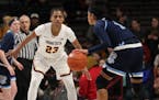 Minnesota Golden Gophers guard Kenisha Bell (23) kept her eye on Rhode Island Rams guard Elemy Colome (1). Bell led all scorers with 28 points.