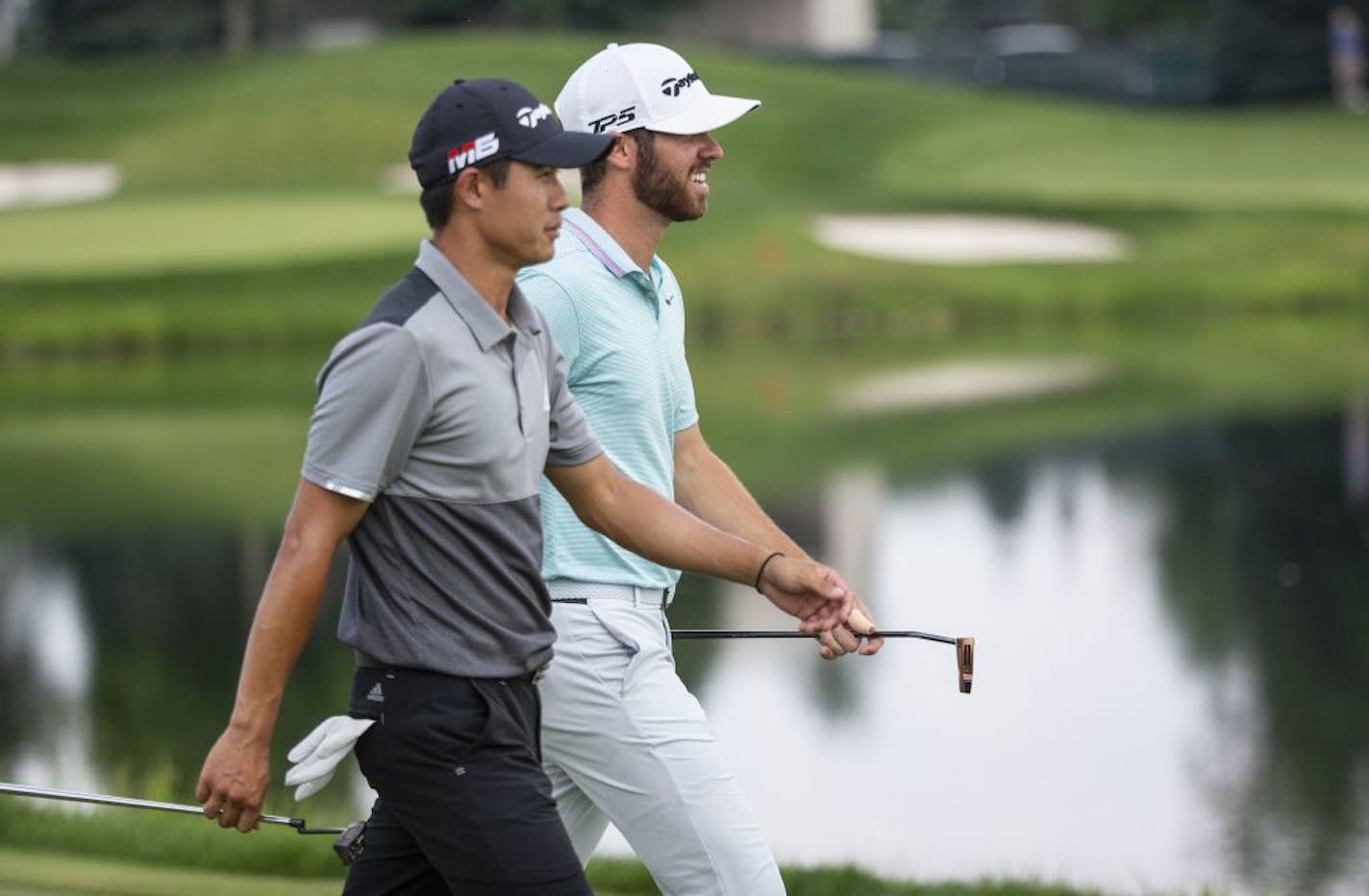 Matthew Wolff and Collin Morikawa talk and share a laugh as they walk down the 17th fairway tied for the lead at -19. ALEX KORMANN ¥ alex.kormann@startribune.com The 3M Open wrapped up on Sunday July 7, 2019 in Blaine, MN.