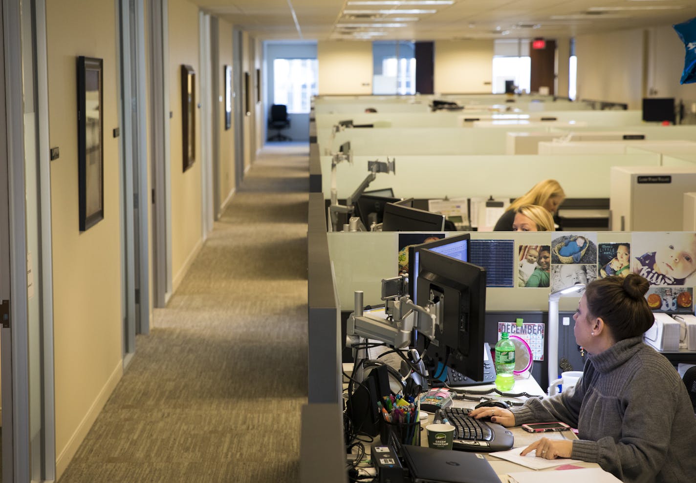 Michelle LaDue worked at her desk at Baker Tilly accounting firm on Tuesday, December 13, 2016, in Minneapolis, Minn. Many of the areas between the closed door offices have been redesigned to have low wall cubicles or have replaced file cabinets with desks. ] RENEE JONES SCHNEIDER &#xef; renee.jones@startribune.com