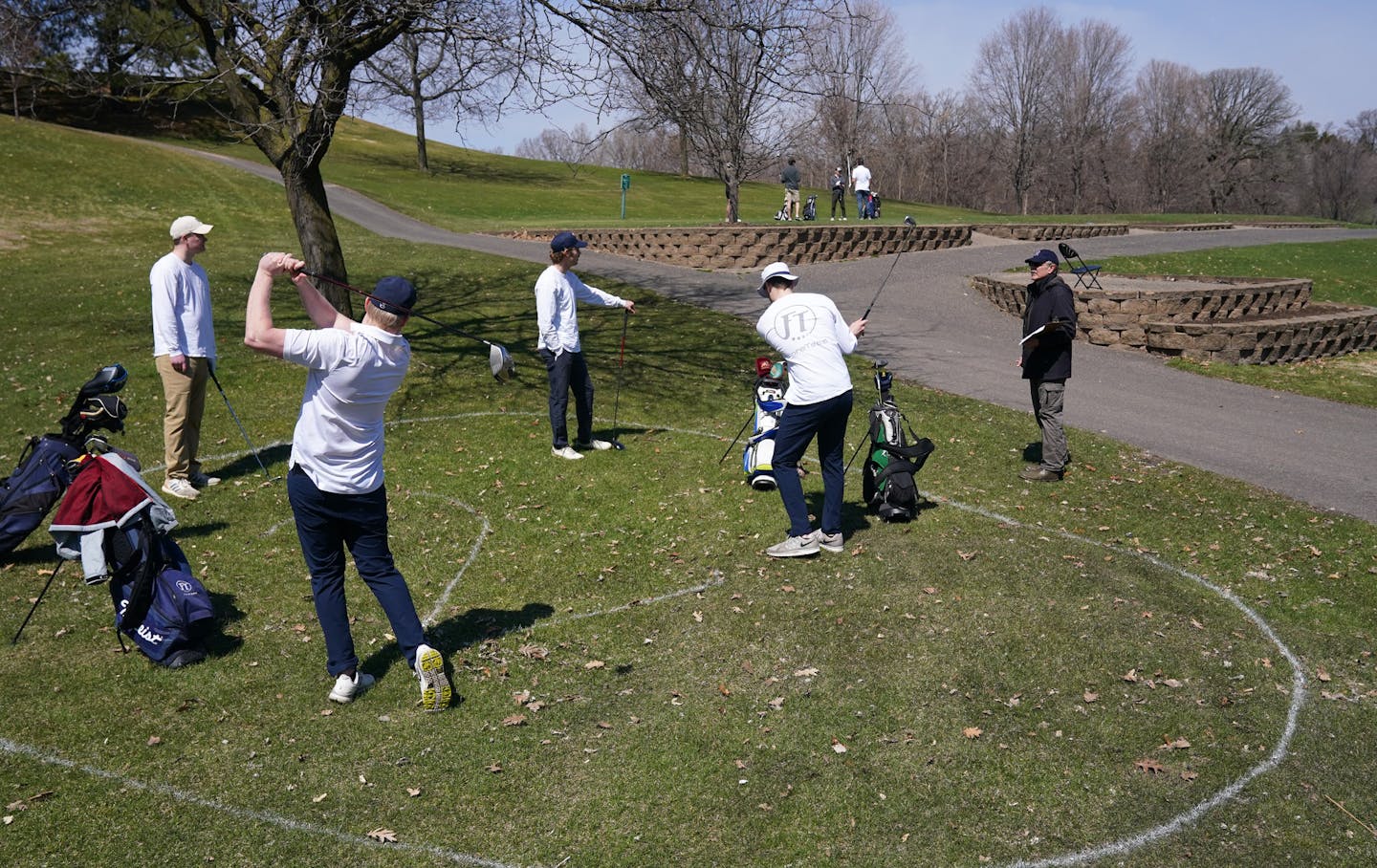 Friends, from left, Sam Rayner, Joey Parise, Peter Gorman and Eric Bradley stood in a pre-marked circle put out by course staff to encourage social distancing as they talked with starter Thomas Stopera, right, while waiting for the start of their round Saturday at Columbia Heights Golf Course. ] ANTHONY SOUFFLE &#x2022; anthony.souffle@startribune.com Golfers took to the fairways on the first day Gov. Tim Walz allowed the reopening of courses and some other outdoor related businesses Saturday, A