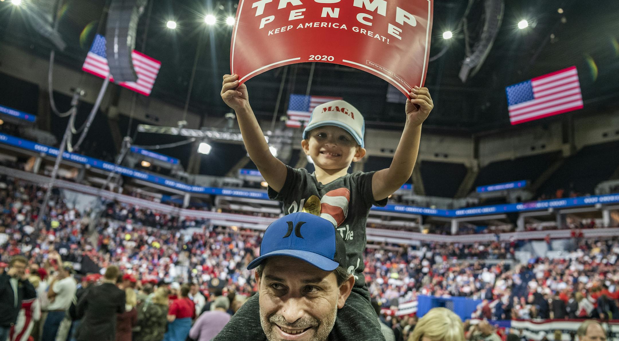 Andre Springer with son Michael,3, held up their sign for Trump. President Trump claimed a record crowd for Target Center.] President Donald Trump addressed his supporters at a rally in Target Center in Minneapolis. RICHARD TSONG-TAATARII ¥ richard.tsong-taatarii@startribune.com