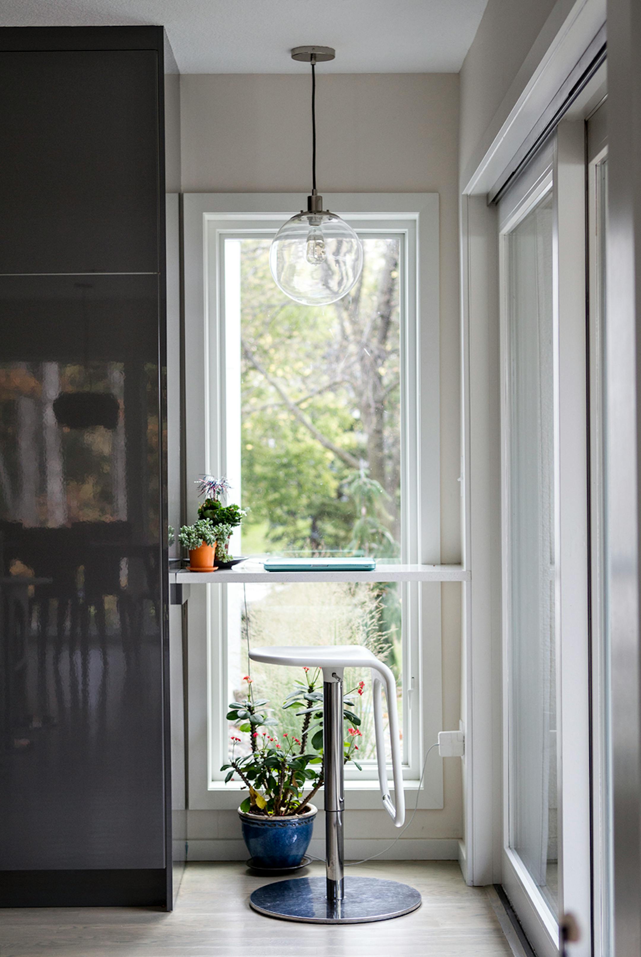A laptop desk in a corner of the kitchen.