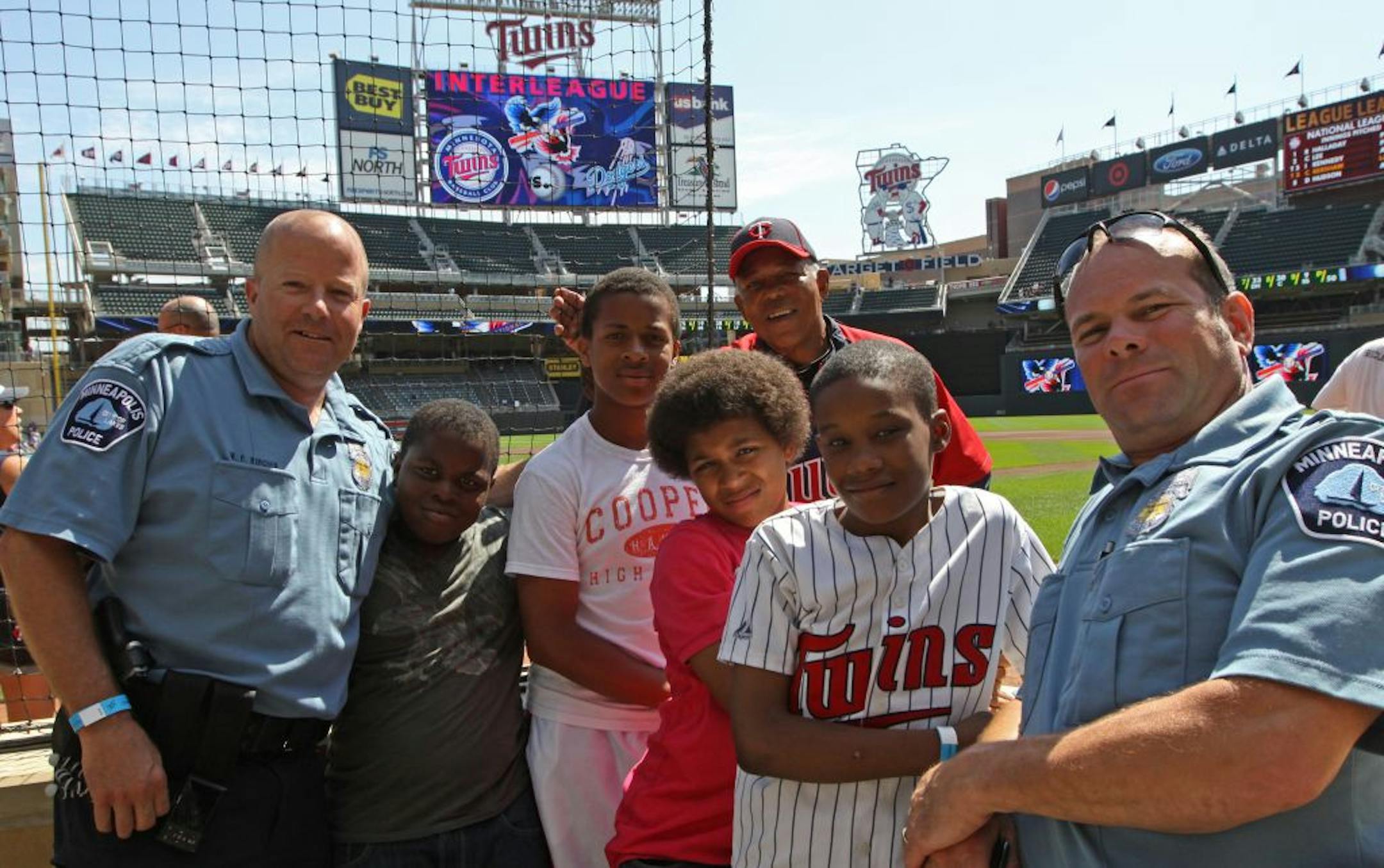 (left to right) Minneapolis Police Officer Bill Kenow, Markil Turner, Kamau Anderson, Cordale Marr, Minnesota Twins Tony Olivia, Amontae Manson and Minneapolis Police Officer Mike Kirchen were photographed before the Minnesota Twins/Los Angeles Dodgers game on Wednesday, June 29th, 2011. The police officers were treating the kids from North Minneapolis to a Twins game and the experience of attending the Champions club and sitting in seats right behind home plate.