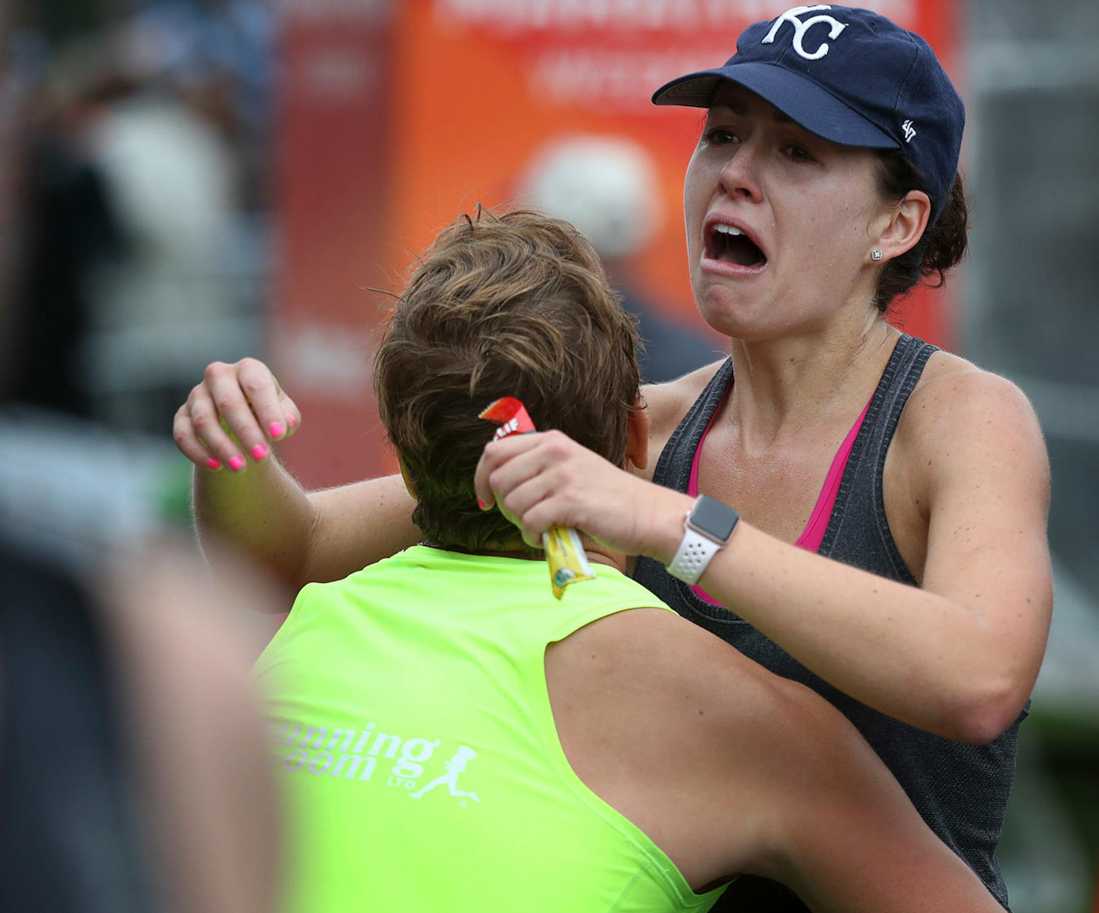 James Dixon left hugged his wife Erica Dixon as the crossed finish line of the Twins Cities Marathon Sunday October 1,2017 in St. Paul, MN.
