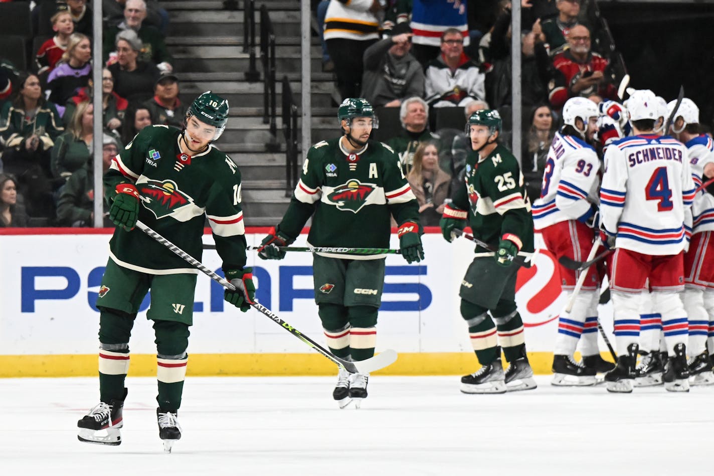 Minnesota Wild players, including center Tyson Jost (10), defenseman Matt Dumba (24) and defenseman Jonas Brodin (25) skate to center ice dejected after allowing a gol in the third period against the New York Rangers Thursday, Oct. 13, 2022 at the Xcel Energy Center in St. Paul, Minn.. ] aaron.lavinsky@startribune.com