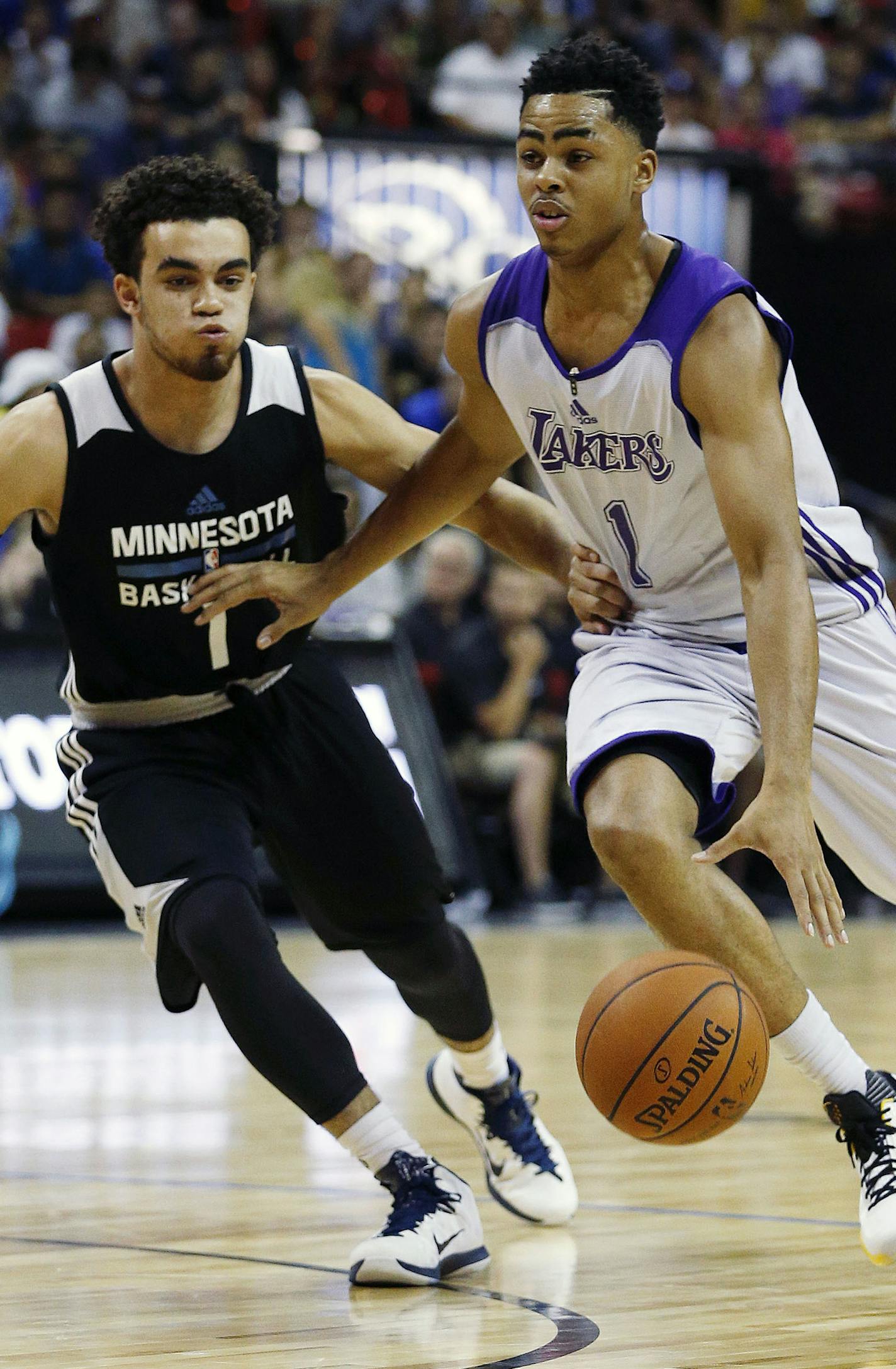 Los Angeles Lakers&#x2019; D'Angelo Russell drives by Minnesota Timberwolves&#x2019; Tyus Jones during the first half of their NBA summer league basketball game Friday, July 10, 2015, in Las Vegas. (AP Photo/John Locher)