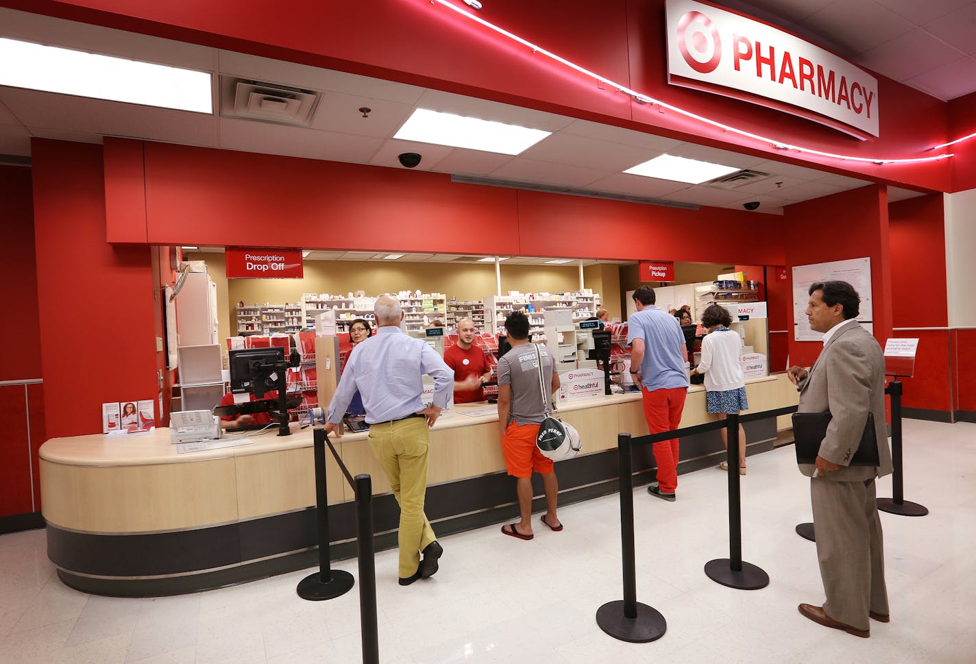 Customers line up at the pharmacy inside the Target in downtown Minneapolis on Monday, June 15, 2015. ] LEILA NAVIDI leila.navidi@startribune.com / BACKGROUND INFORMATION: Target has sold its 1,660 pharmacies and 80 in-store clinics to CVS in a $1.9 billion deal.