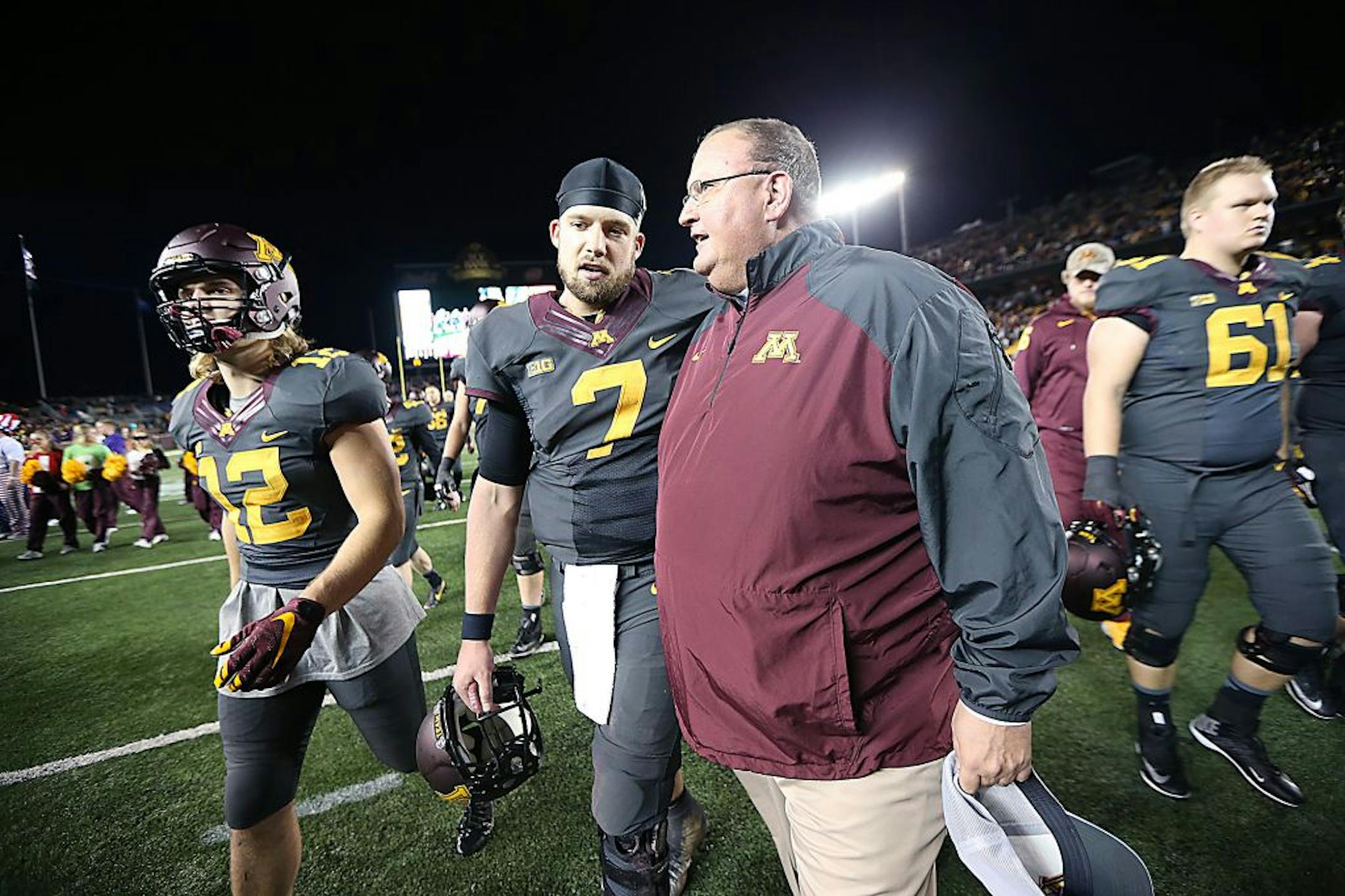 Interim Head Coach Tracy Claeys and Minnesota's quarterback Mitch Leidner walked off the field together after Michigan defeated Minnesota 29-26 at TCF Bank Stadium, Saturday, October 31, 2015 in Minneapolis, MN.