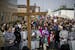 Pro-life supporters stood in front of cross as they protested outside Planned Parenthood on good Friday in St. Paul, Minn., on April 14, 2017. In the 