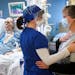 Critical care nurse Holly Vilione and Deb Ulrich, of Norwood Young America, comforted each other as Deb visited her husband Rick, 60, for the first ti