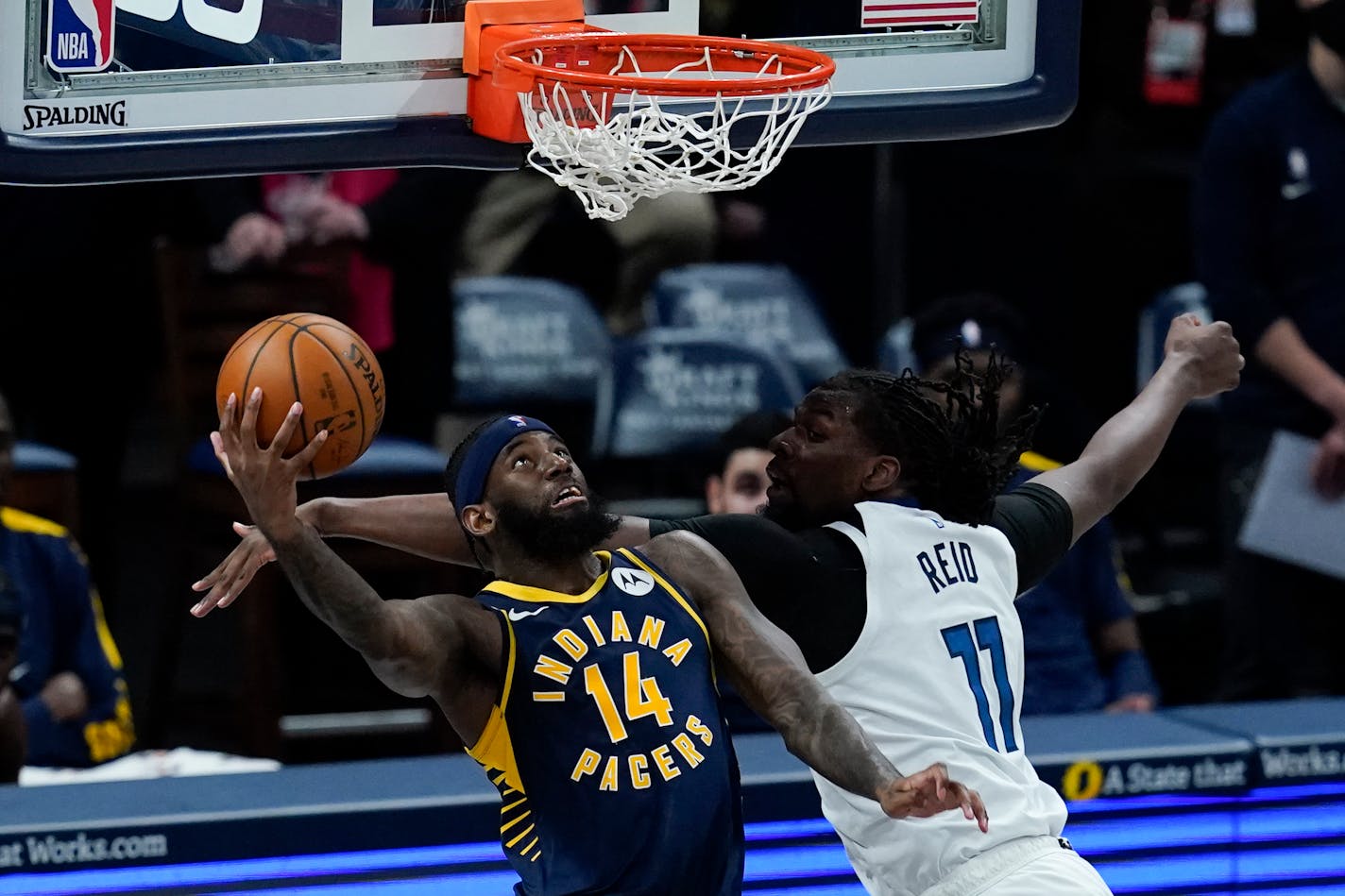 Indiana's JaKarr Sampson goes up for a dunk against the Timberwolves' Naz Reid during the first half