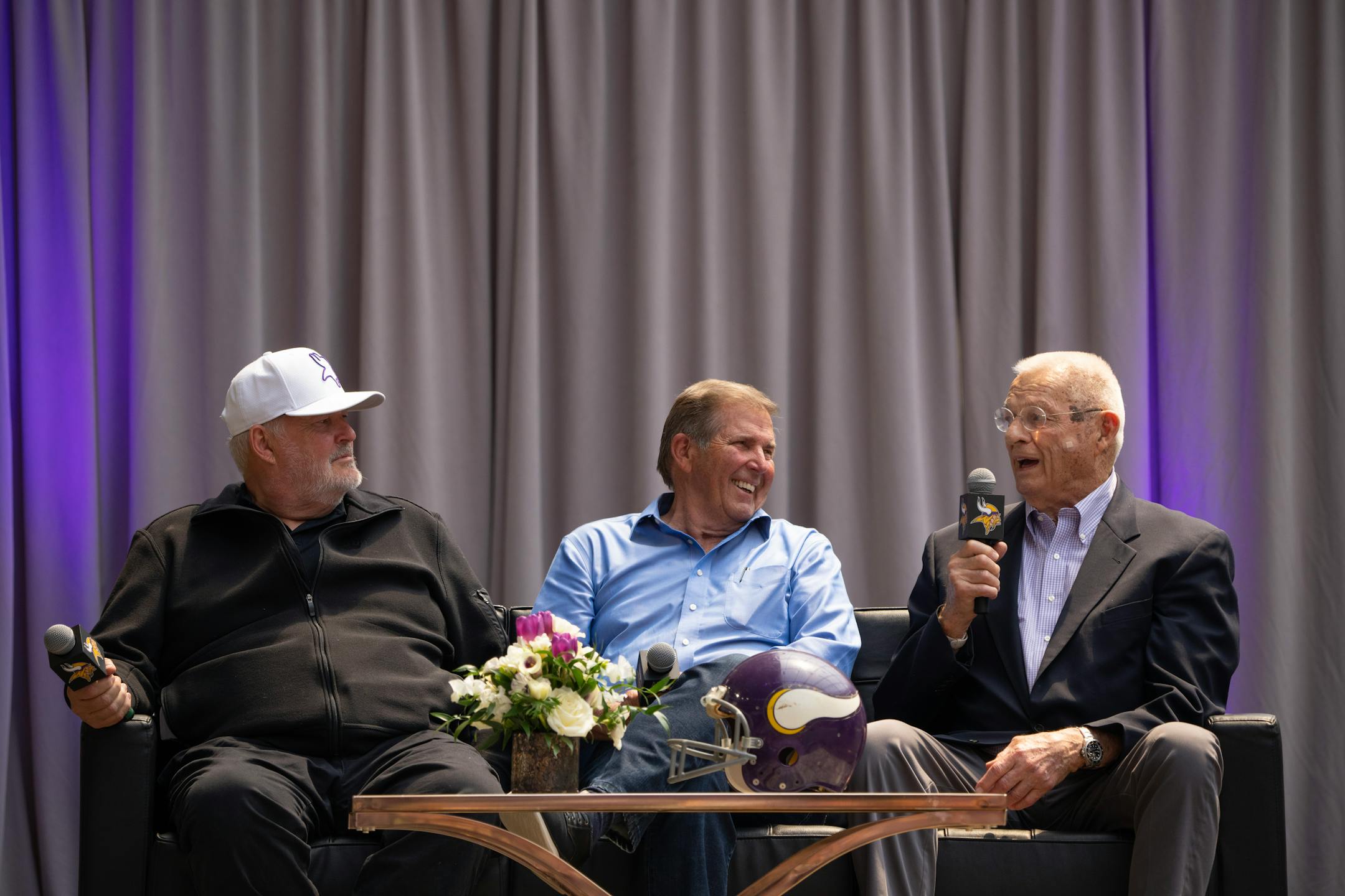 Bud Grant's son, Mike Grant, left, and former Minneapolis Tribune outdoors columnist Ron Schara listened as former Vikings assistant coach Paul Wiggin told a story about Bud Grant