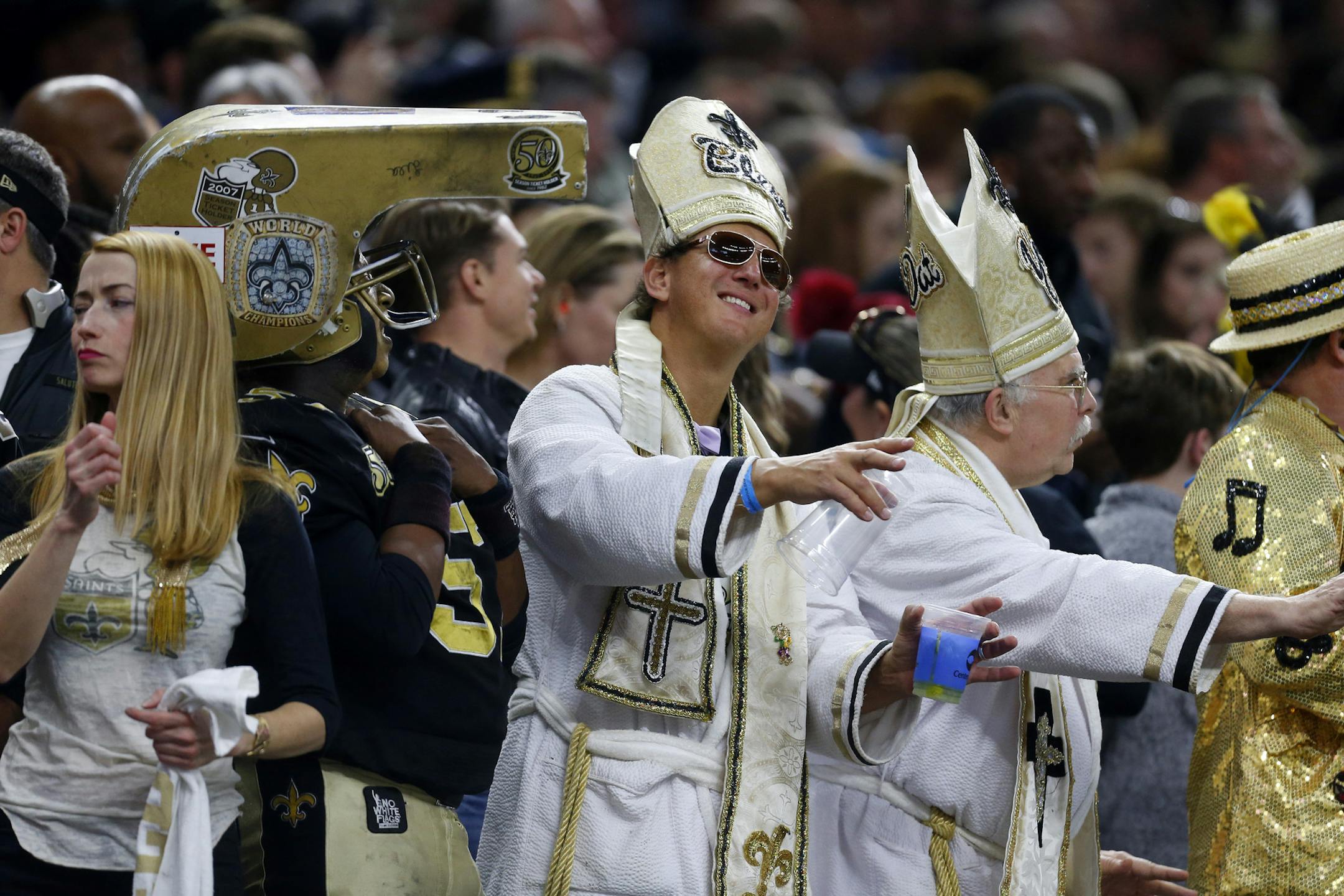 New Orleans Saints fans cheer in the first half of an NFL football game against the Carolina Panthers in New Orleans, Sunday, Jan. 7, 2018. (AP Photo/Butch Dill)