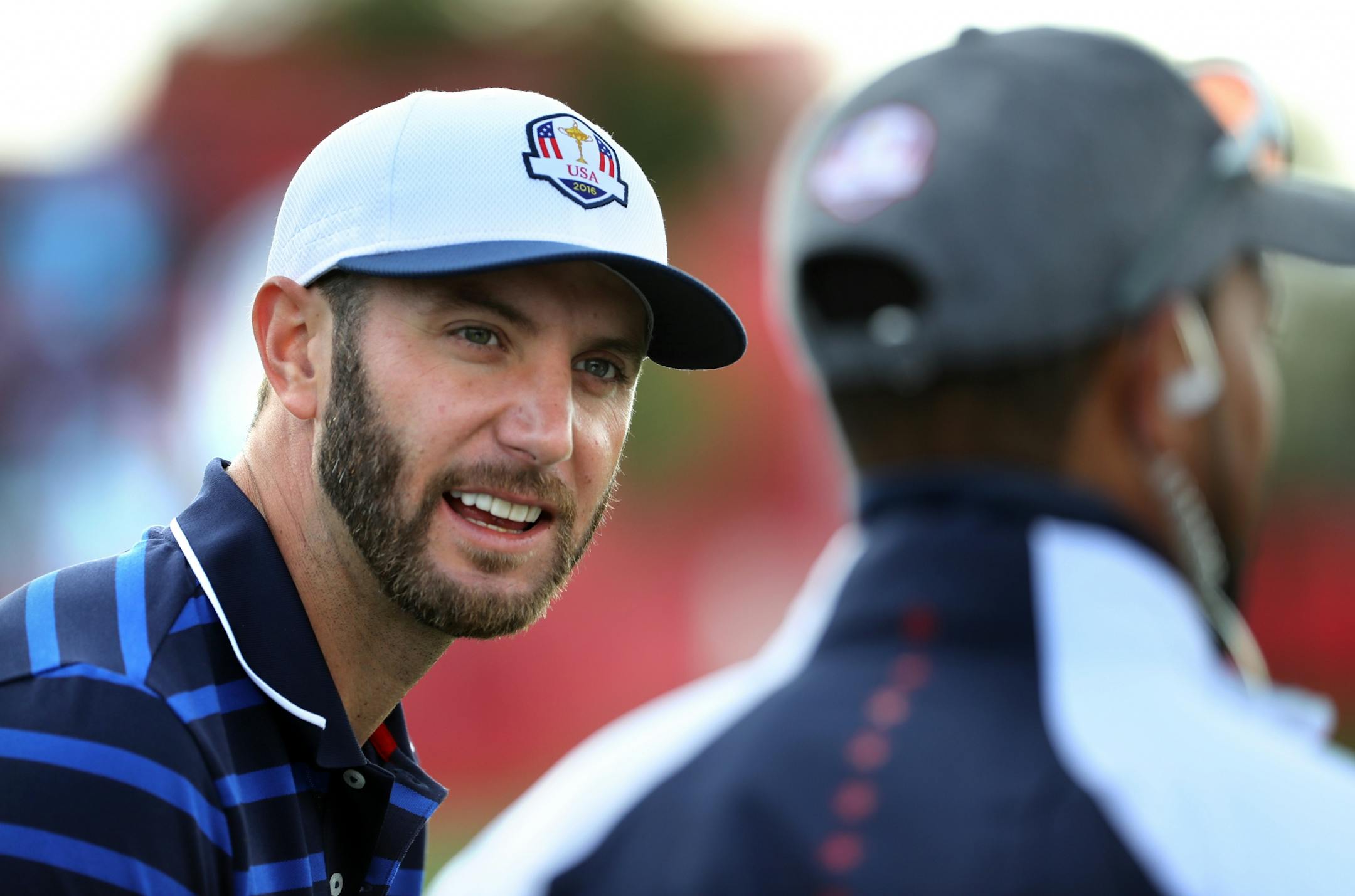 Team USA�s Dustin Johnson gets advice from Vice Captain Tiger Woods on the practice tee Thursday morning.