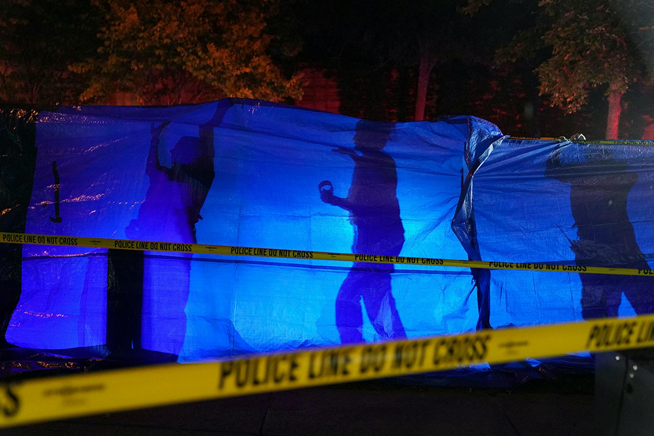 Police put up a blue tarp to block the view of a body at the scene of an officer involved shooting on Saturday, Sept. 7, 2019, in Richfield, Minn. Police shot and killed a driver following a chase after he apparently emerged from his car holding a knife and refused their commands to drop it.