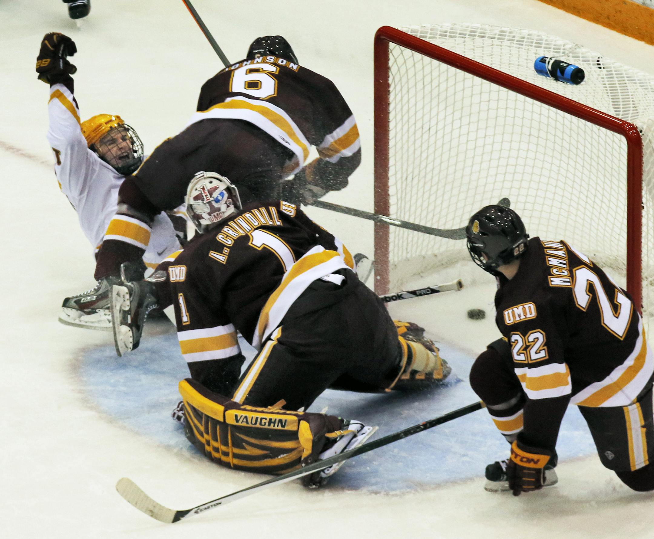 UM Gophers vs. UMD Bulldogs hockey. Gophers A.J. Michaelson, left, began his celebration after beating UMD goalie Aaron Crandall for a first period goal. (MARLIN LEVISON/STARTRIBUNE(mlevison@startribune.com)