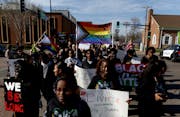 Demonstrators march to the Sandburg Education Center in Anoka during a Youth for Unity rally and march before Monday's Anoka-Hennepin school board mee