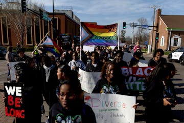 Demonstrators march to the Sandburg Education Center in Anoka during a Youth for Unity rally and march before Monday's Anoka-Hennepin school board mee