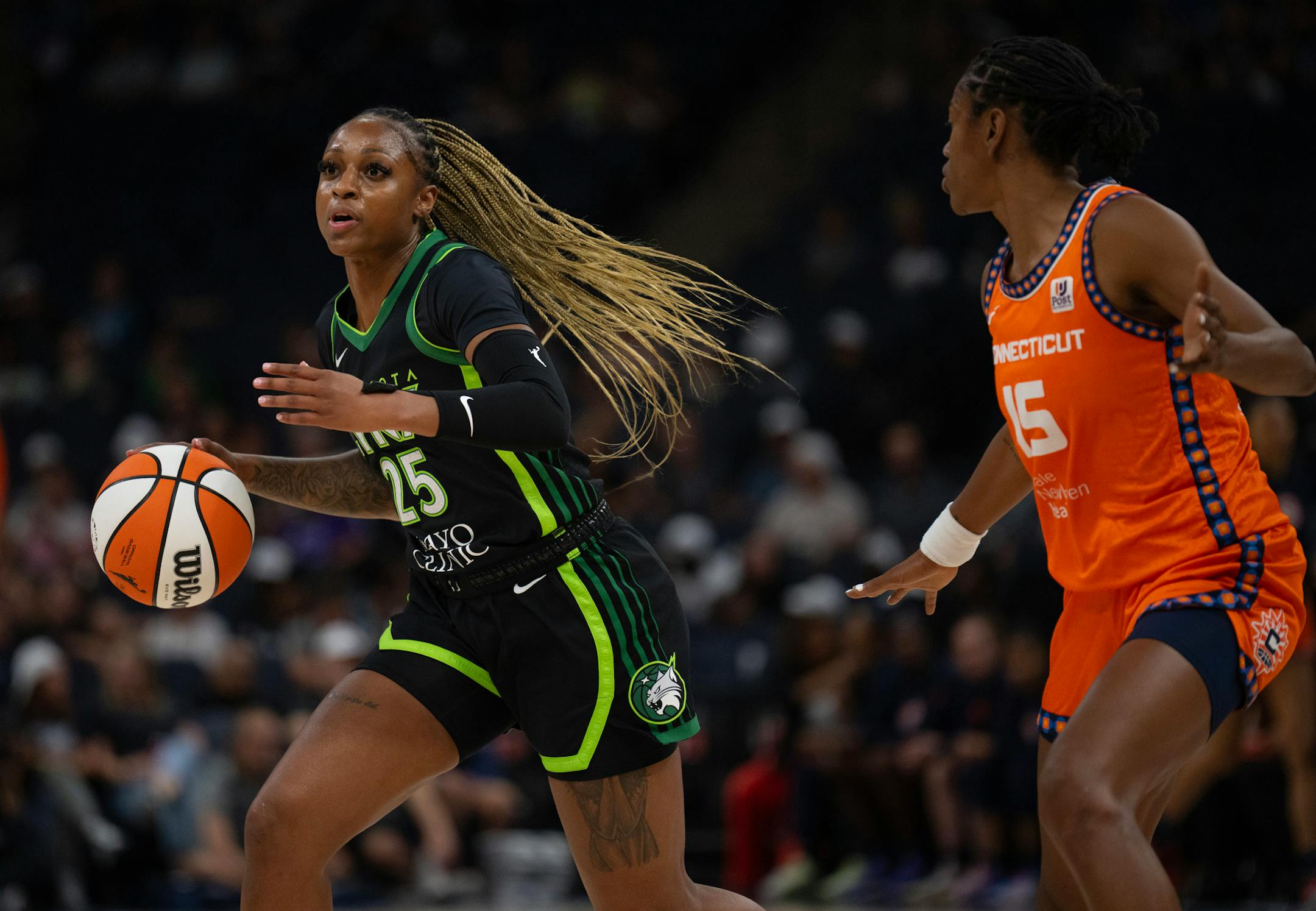 Minnesota Lynx guard Tiffany Mitchell (25) moved the ball ahead of Connecticut Sun guard Tiffany Hayes (15) in the first quarter Thursday night. The Minnesota Lynx faced the Connecticut Sun in a WNBA game Thursday night, June 22, 2023 at Target Center in Minneapolis.