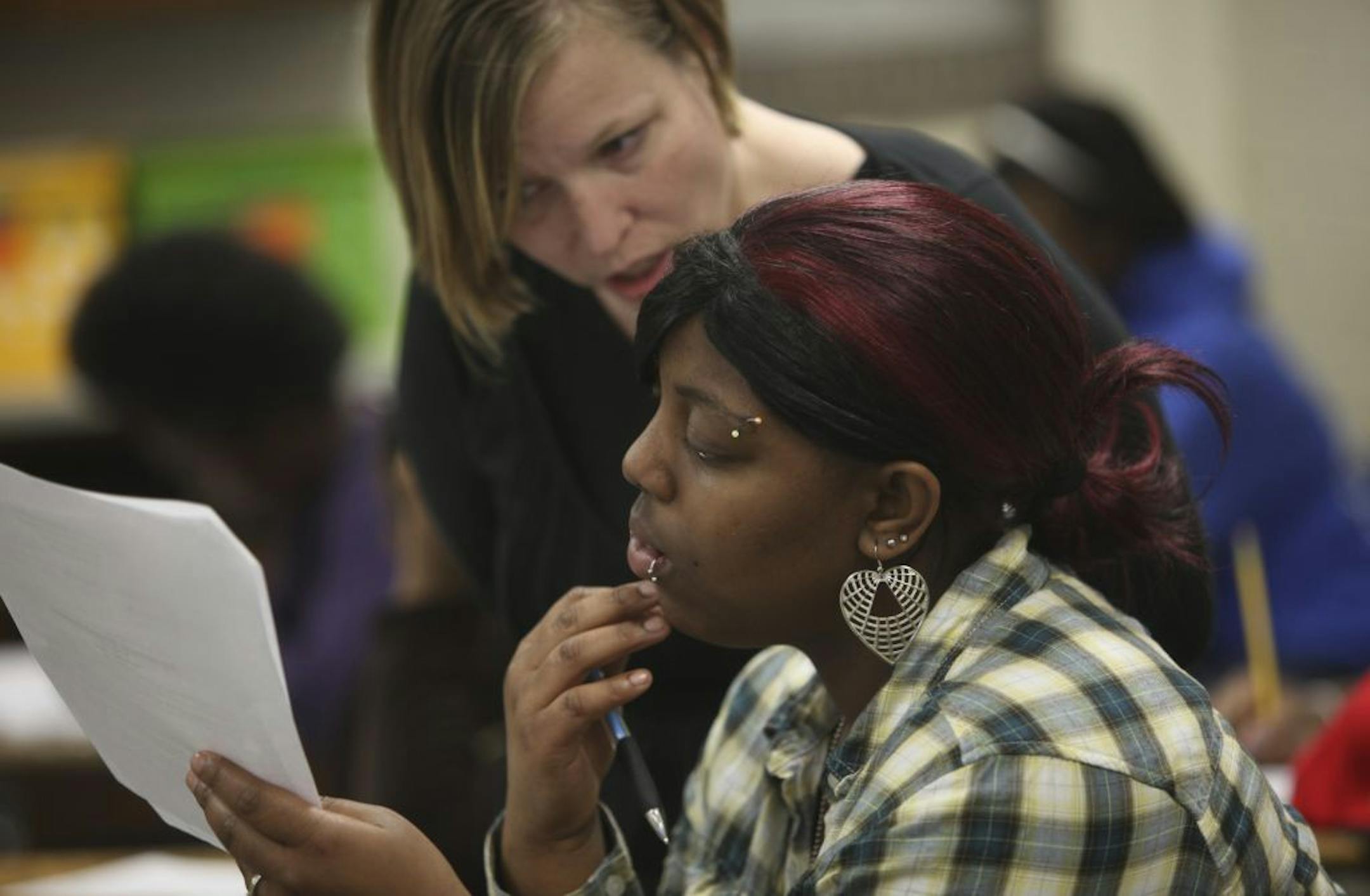 Teacher Tina Schaefer answered questions for Taricka Tolliver during a recent ninth-grade English class at North High School in Minneapolis.