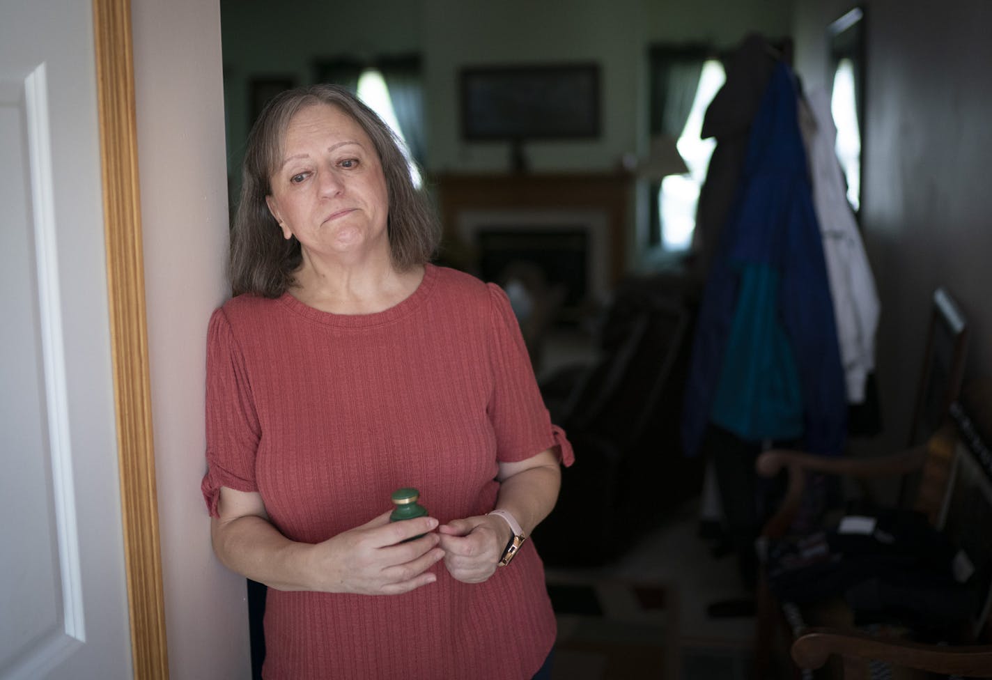 Patty Secrest held a small urn with part of the ashes of her partner of 18 years, Don Lydick, in her Stillwater home. Both Secrest and Lydick were hospitalized for COVID-19 in late March. Lydick died on April 10; Secrest is recovering after waking from a medically induced coma.