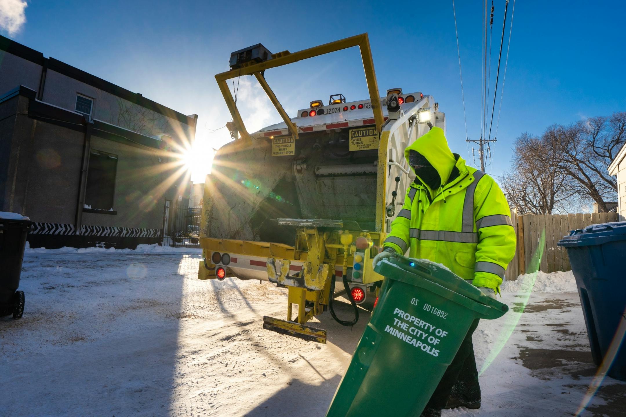 Rich Thompson of the Minneapolis Public Works department collected organic refuse along his route. Workers had the option of sitting out the coldest day in 20 years but all chose to work their routes. They train for cold safety and felt prepared for record cold.