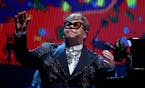 Rock legend Elton John acknolwdges the applause from a sold-out crowd during the first of several farewell performances at Staples Center in Los Angel