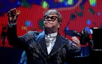 Rock legend Elton John acknolwdges the applause from a sold-out crowd during the first of several farewell performances at Staples Center in Los Angel