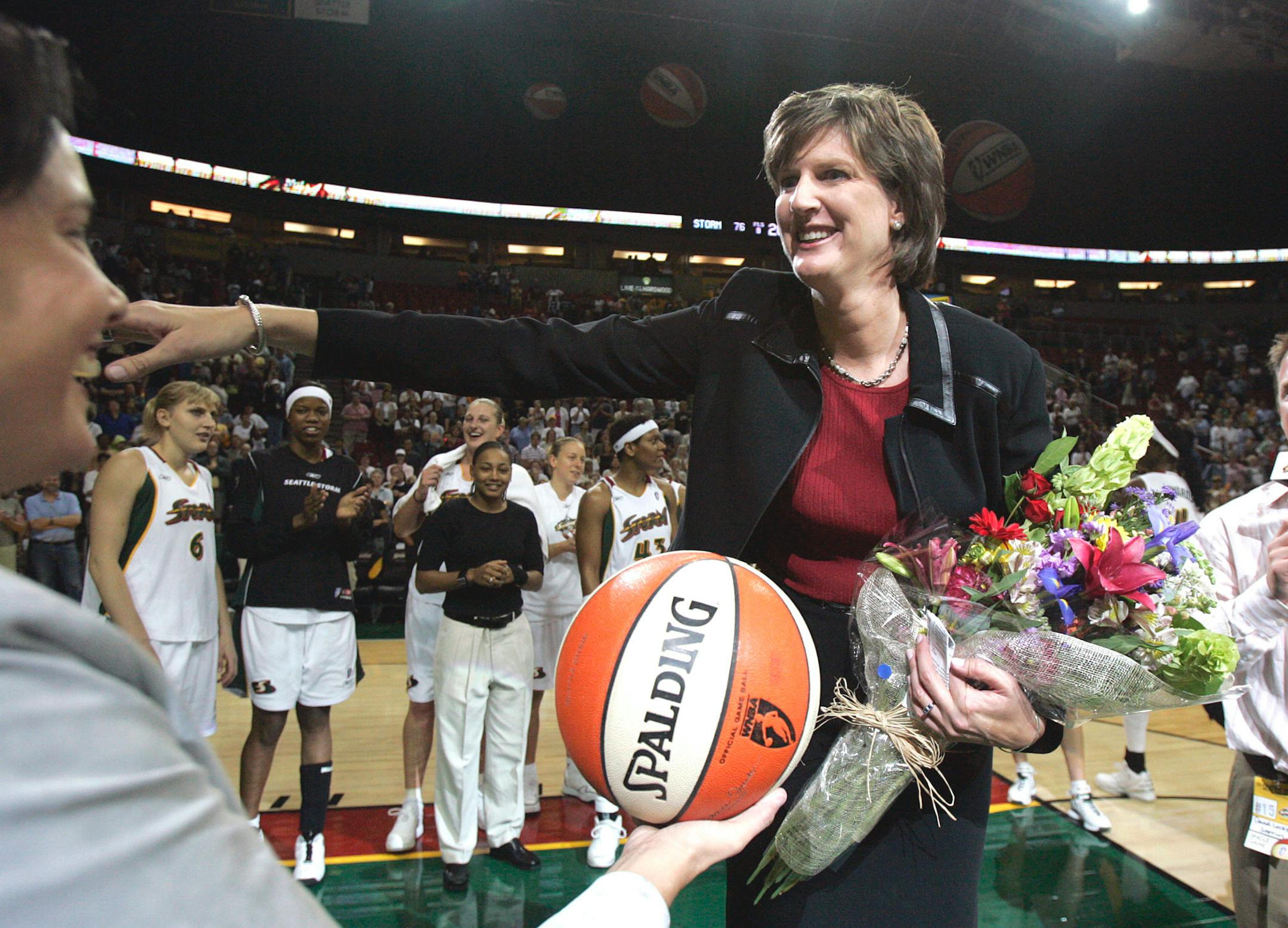 Anne Donovan, right, smiles after her 100th career WNBA victory as a coach