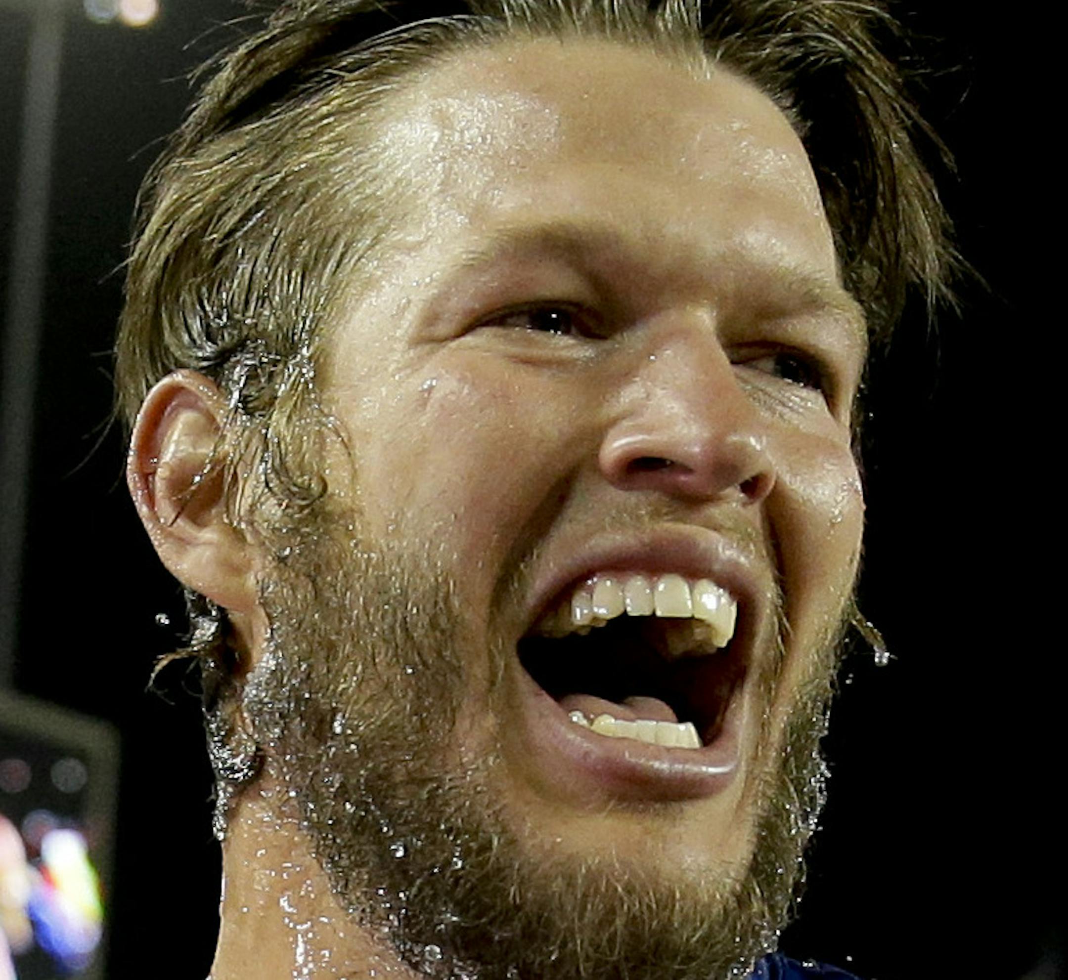 Los Angeles Dodgers starting pitcher Clayton Kershaw celebrates his no hitter against the Colorado Rockies after a baseball game in Los Angeles, Wednesday, June 18, 2014. (AP Photo/Chris Carlson)