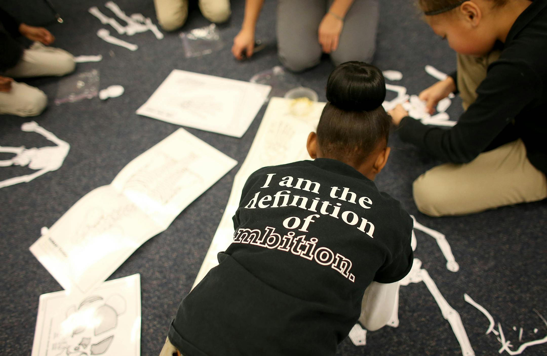 Yrneh Williams 8, wore her FAIRnation shirt as she put together her skeleton during class ] (KYNDELL HARKNESS/STAR TRIBUNE) kyndell.harkness@startribune.com At FAIR School downtown in Minneapolis Min., Tuesday, January 20, 2015. With the West Metro Education Program on the verge of getting out of the school business, the future of two of the metro-area's integration districts seems questionable at best.