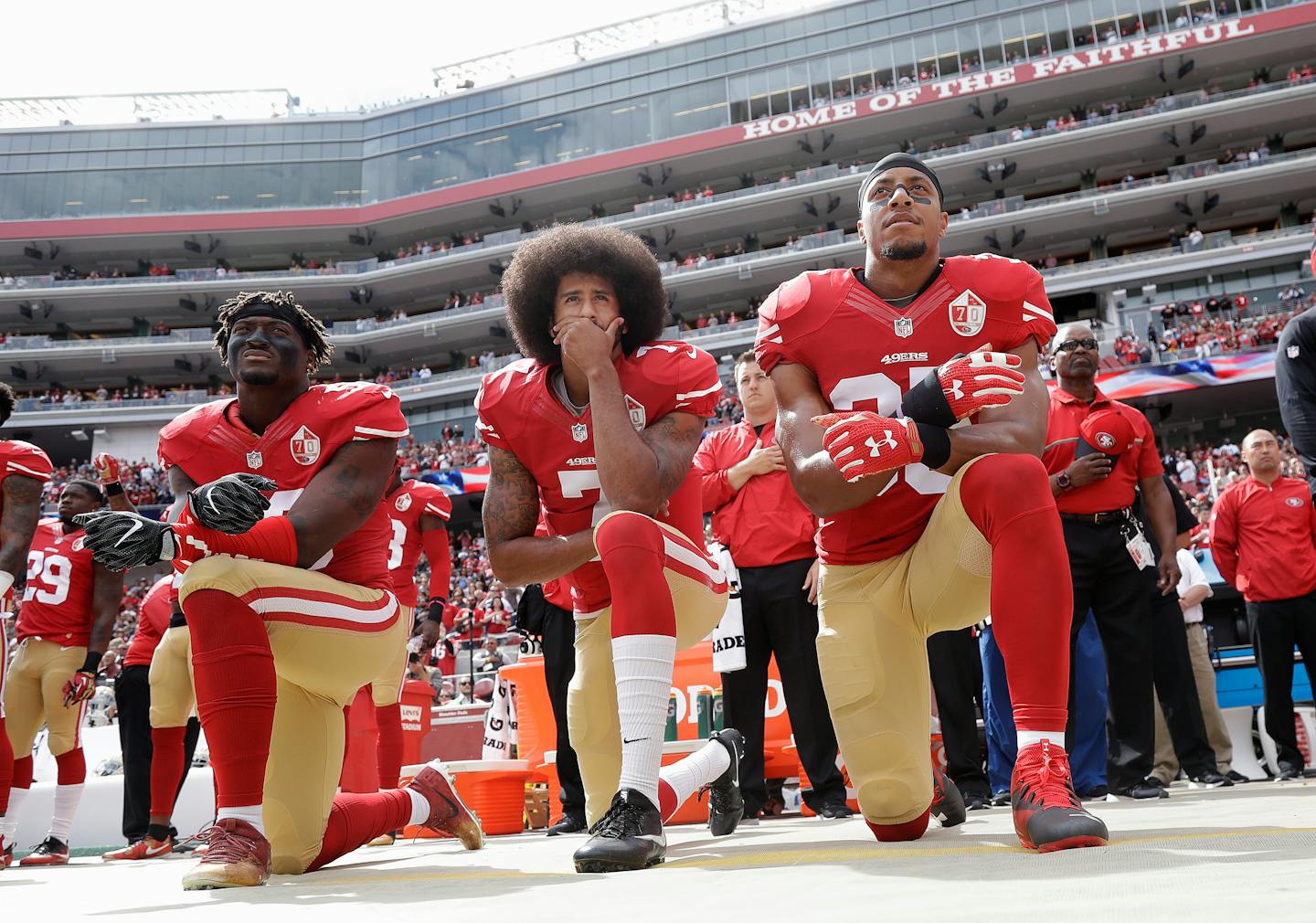 FILE - In this Oct. 2, 2016, file photo, from left, San Francisco 49ers outside linebacker Eli Harold, quarterback Colin Kaepernick and safety Eric Reid kneel during the national anthem before an NFL football game against the Dallas Cowboys in Santa Clara, Calif. When Colin Kaepernick took a knee during the national anthem to take a stand against police brutality, racial injustice and social inequality, he was vilified by people who considered it an offense against the country, the flag and the military. Nearly four years later, it seems more people are starting to side with Kaepernick's peaceful protest and now are calling out those who don't understand the intent behind his action. (AP Photo/Marcio Jose Sanchez, File)