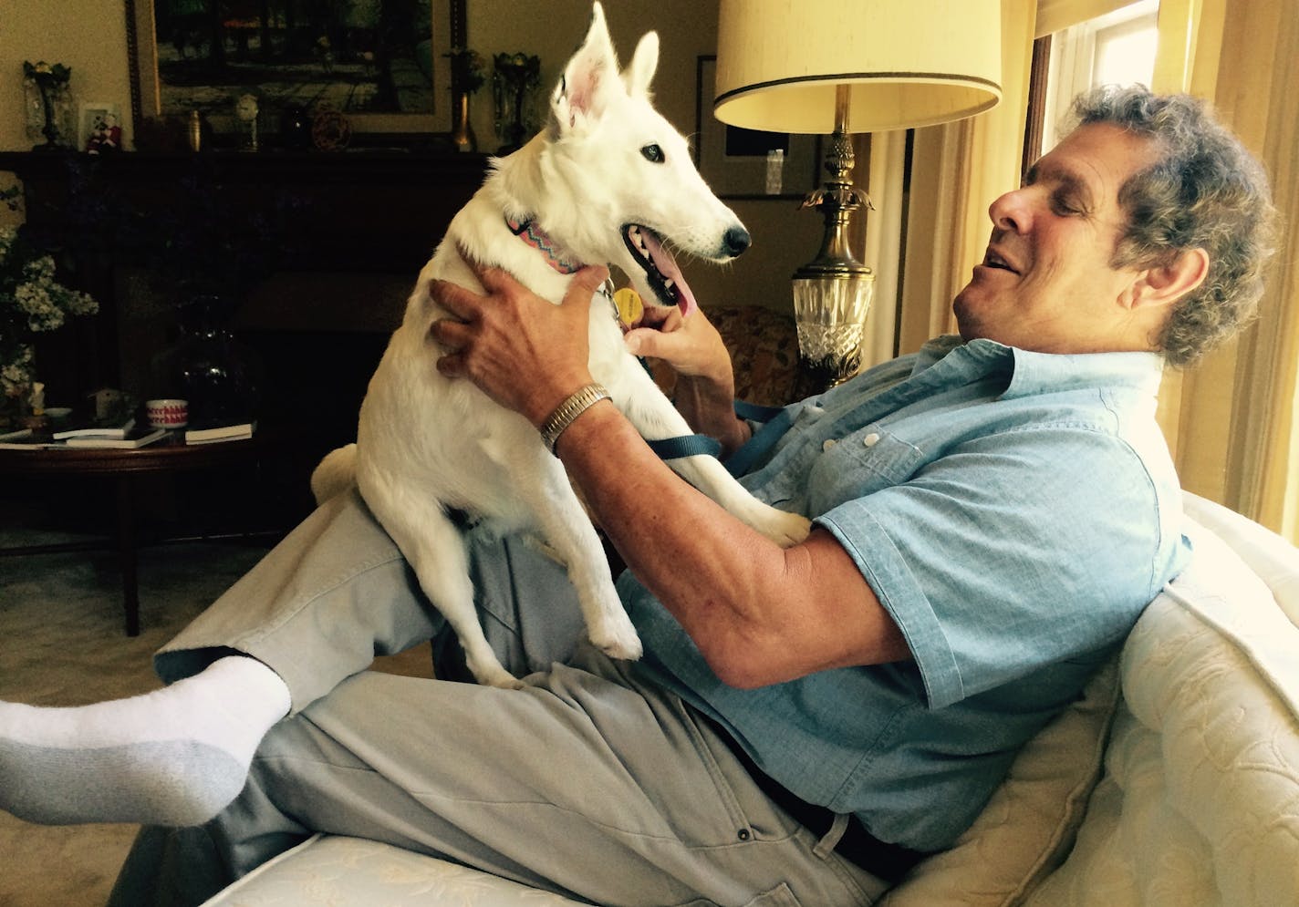 Dennis Lang spends time with his fox terrier, Allie, at his home in St. Paul. Lang said he's confident he will prevail in his legal battle with a self-proclaimed miracle healer who says he's been defamed by Lang.