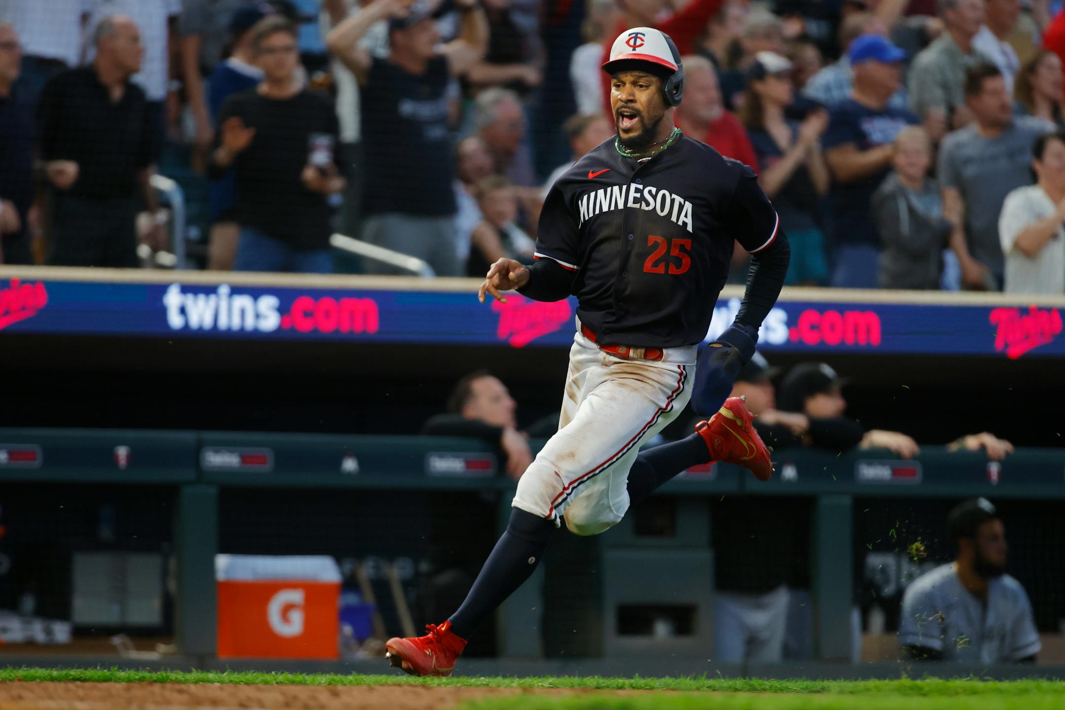 Minnesota Twins' Byron Buxton scores on double by teammate Christian Vazquez against the Chicago White Sox in the seventh inning of a baseball game Saturday, July 22, 2023, in Minneapolis. (AP Photo/Bruce Kluckhohn)