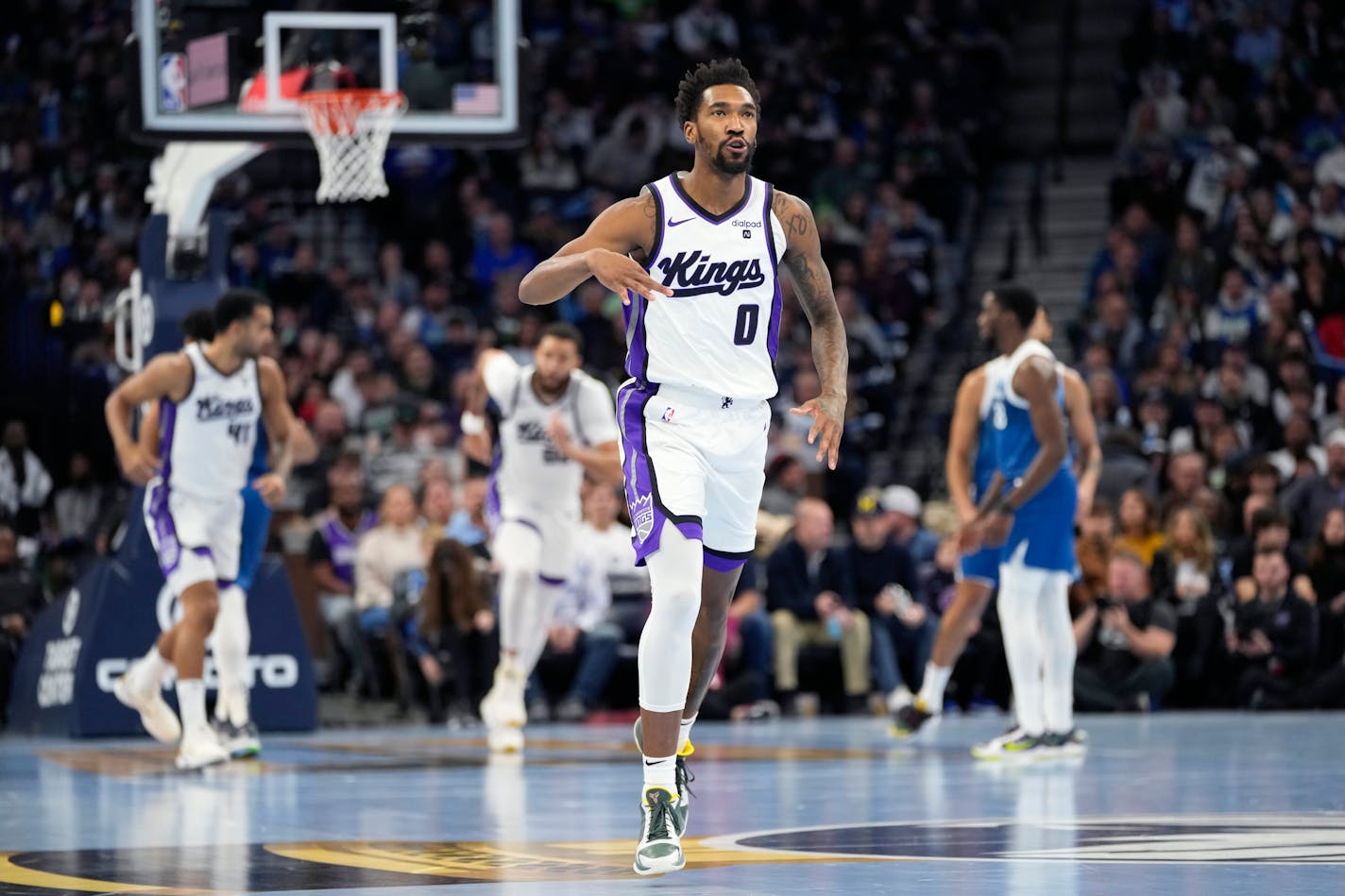 Kings guard Malik Monk gestured after making a 3-point basket during the first half Friday against the Wolves.