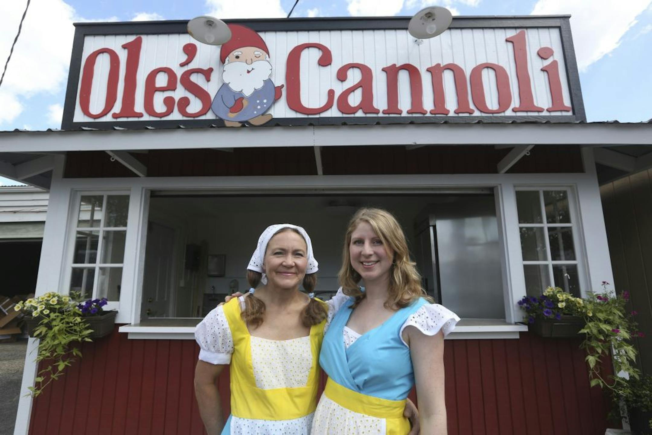 Pam Olson, left, and daughter Marta Lindsey outside their new State Fair booth, Ole's Cannoli, in Heritage Square.