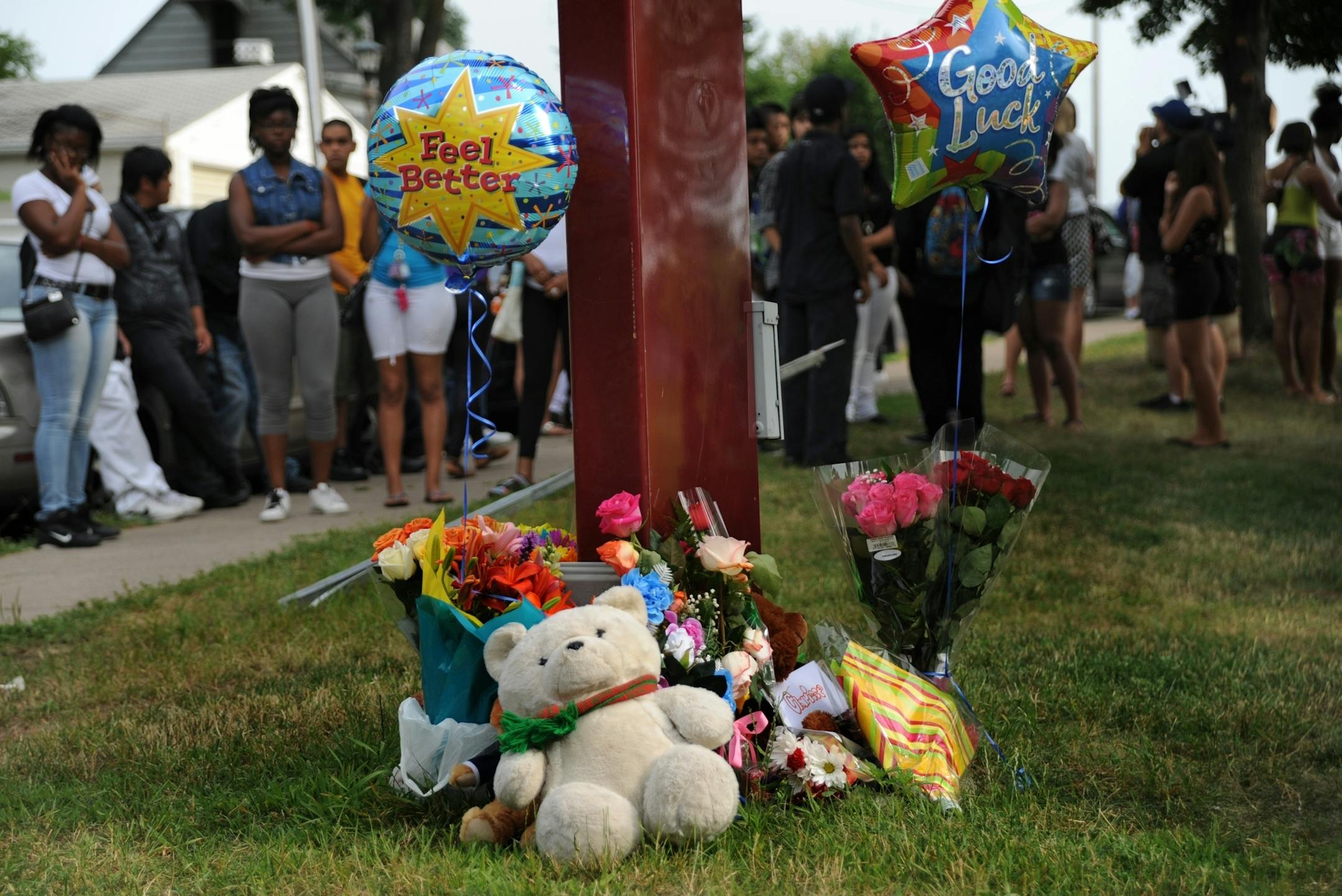 Friends and classmates of Clarisse Grime, 16, of St. Paul who died yesterday at Harding High School came to place flowers and grieve near where she died after being hit by an out of control SUV near the schools sign.