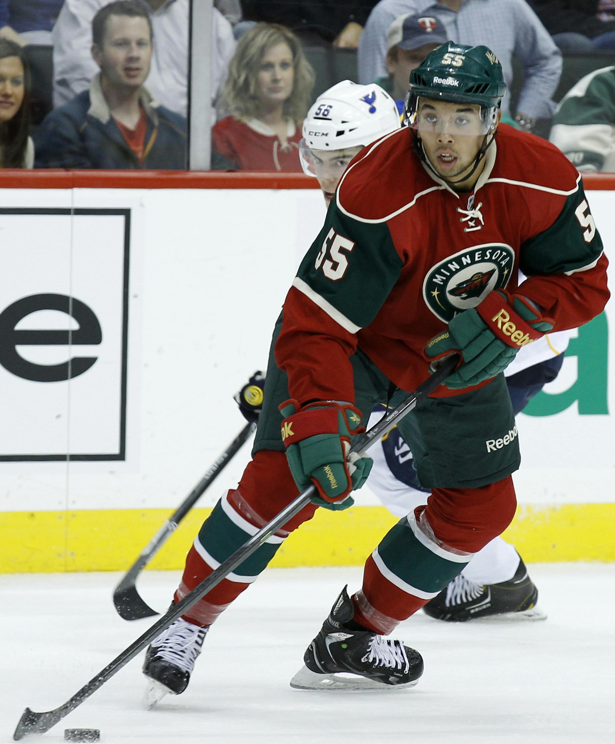Minnesota Wild defenseman Mathew Dumba controls the puck during the second period of a preseason NHL hockey game against the St. Louis Blues in St. Paul, Minn., Wednesday, Sept. 25, 2013. (AP Photo/Ann Heisenfelt) ORG XMIT: MIN2013101621023918