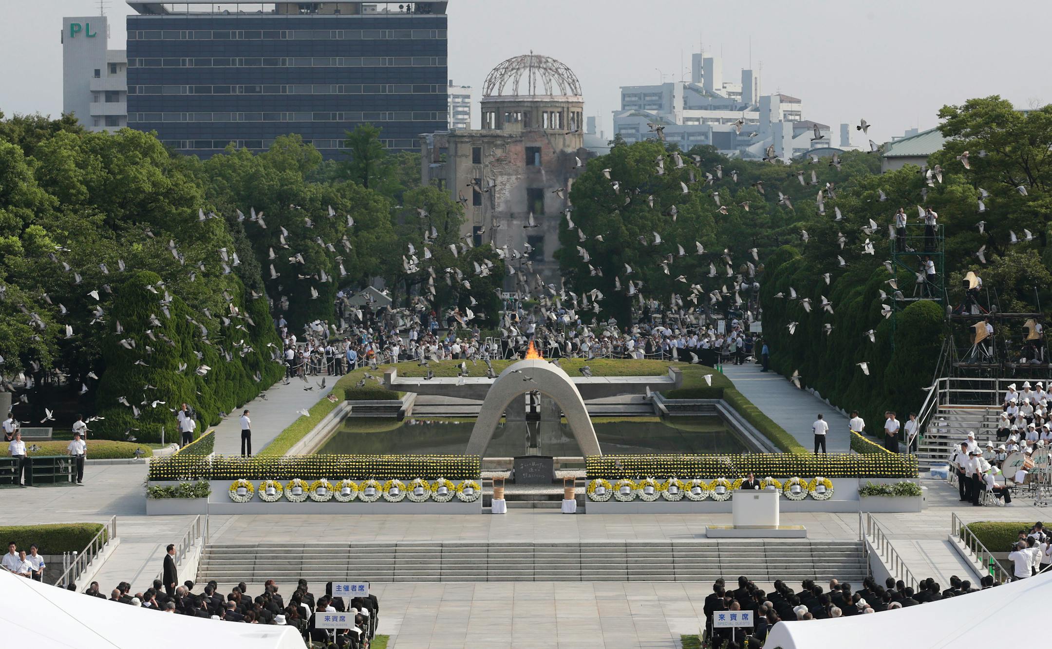 In this Aug. 6, 2013 file photo, doves fly over the cenotaph dedicated to the victims of the atomic bombing at the Hiroshima Peace Memorial Park during a ceremony marking the 68th anniversary of the bombing, in Hiroshima, western Japan.
