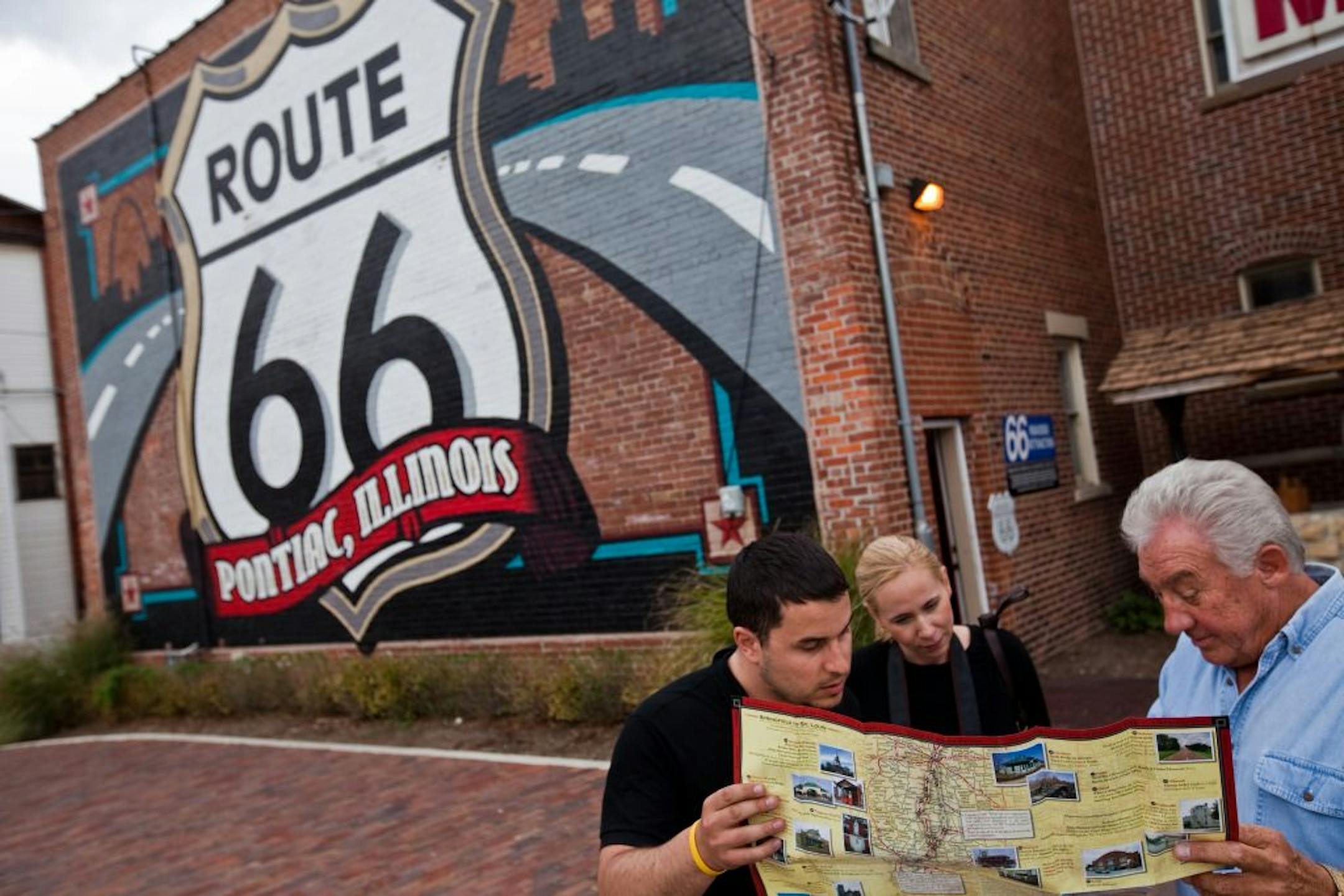 Author John Weiss, right, gave suggestions to tourists Sonny Dudas and Emilia Mattsson at the Route 66 Hall of Fame in Pontiac, Ill.